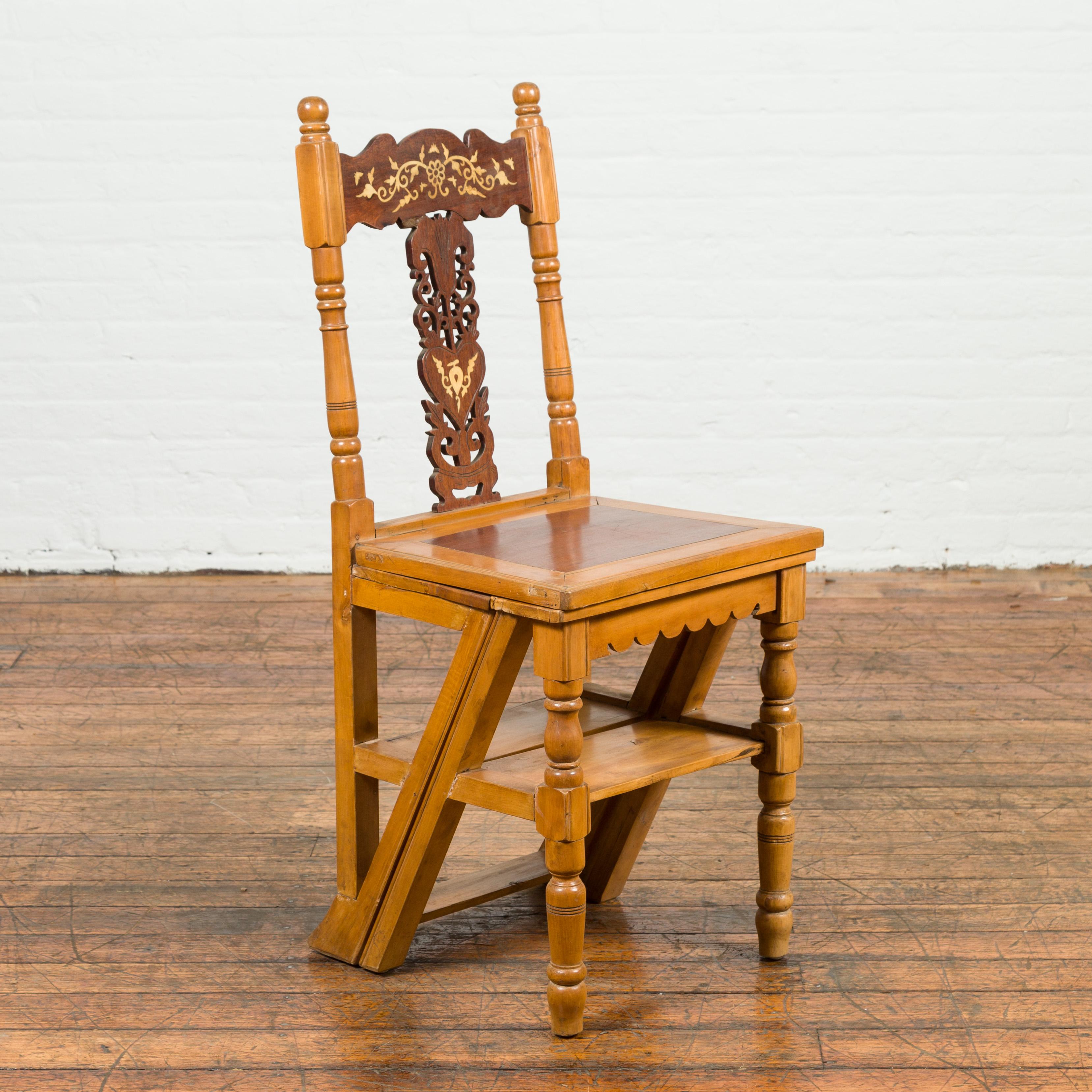 An Indian vintage metamorphic carved side chair from the mid-20th century, with mother of pearl inlay and natural patina. Created in India during the midcentury period, this convenient metamorphic side chair opens up to become a stepladder.