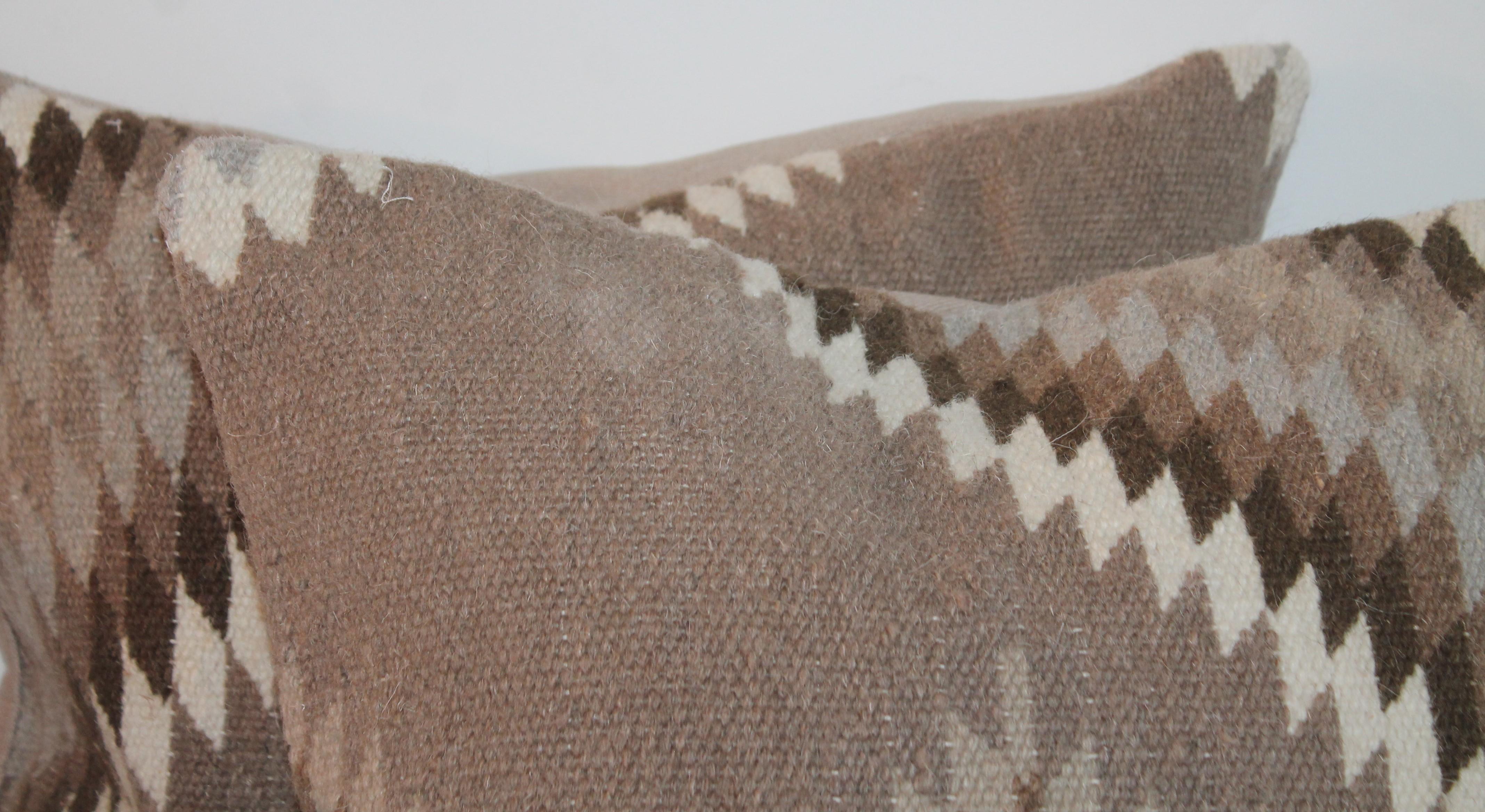 These finely handwoven pillows have natural grey linen backing and in good condition.