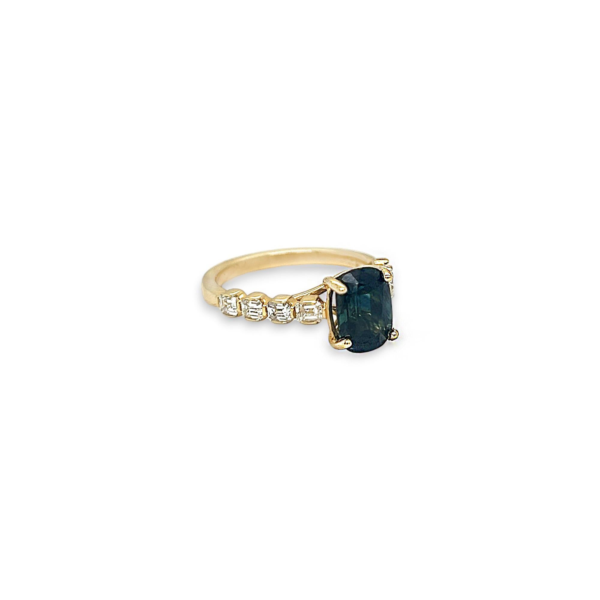 This gorgeous indicolite (tourmaline) and diamond ring features a 2.40 ct oval indicolite center stone and 0.72 total ct of emerald cut diamonds on band. The diamonds are G/H color and VS clarity. Set in 14k yellow gold, this ring is currently as