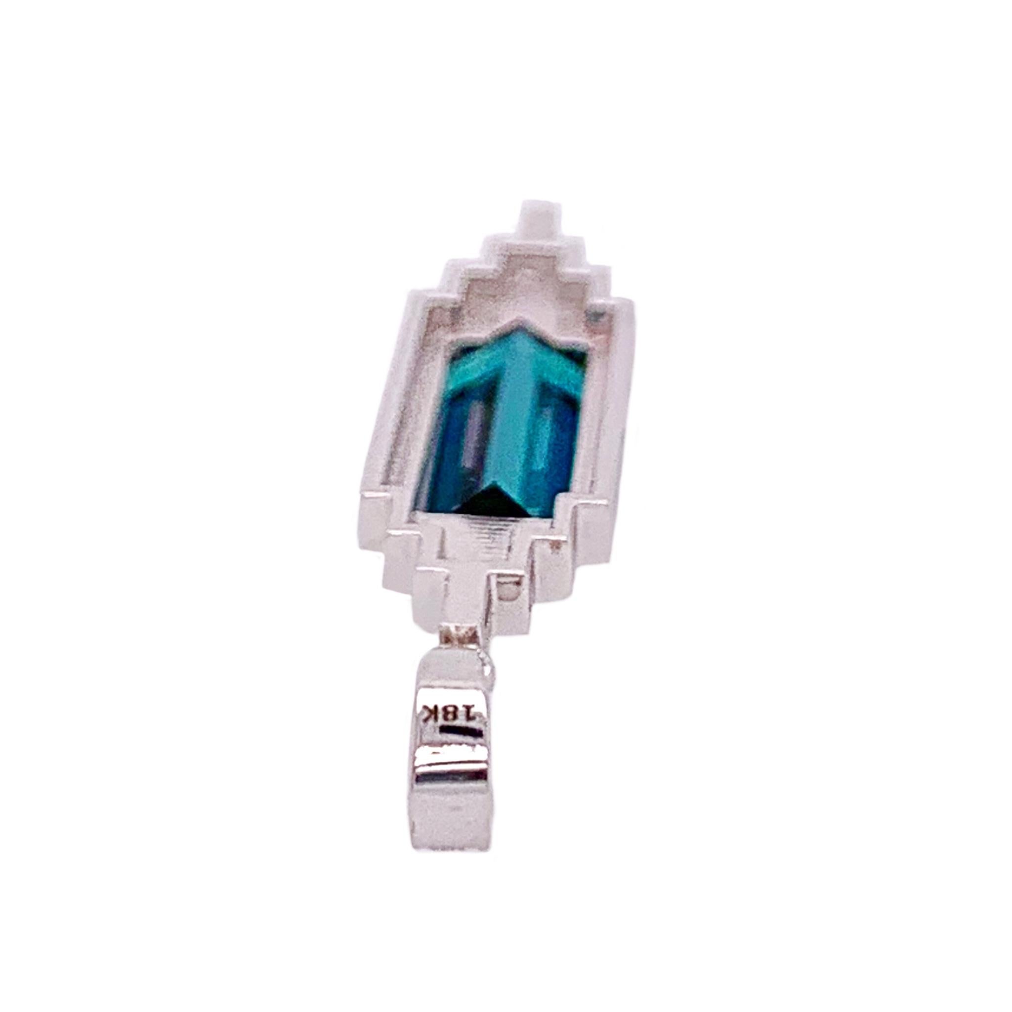 Brand new custom designed art deco style 18K white gold pendant set with a stunning emerald cut indicolite blue tourmaline weighing 2.90cts and 80 brilliant cut diamonds total weight of 0.88cts. They average VS2-SI1 clarity and G-H color.  Suspended