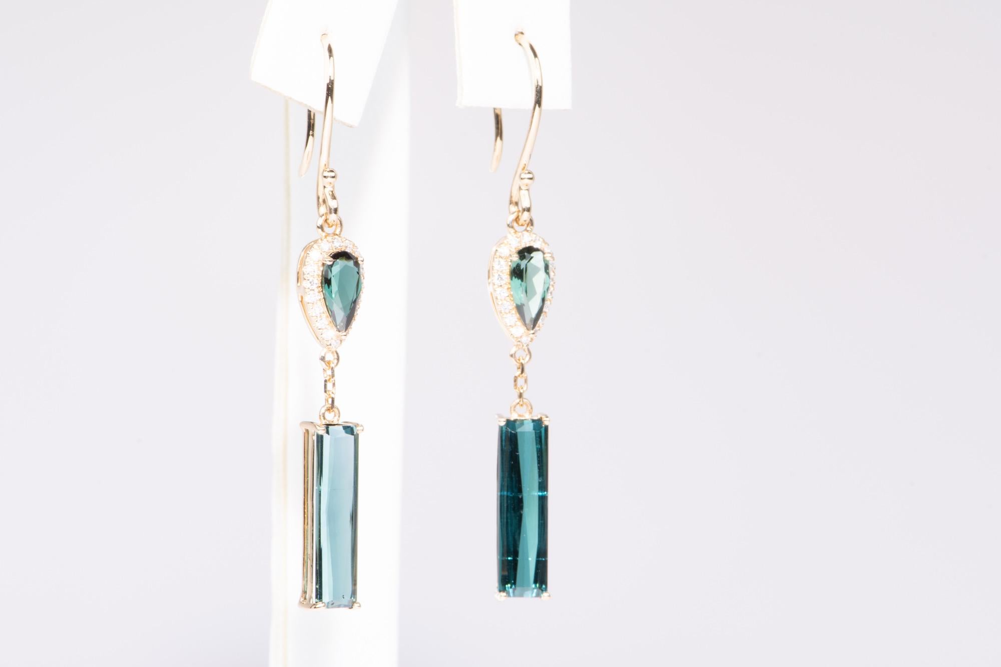 ♥ Indicolite Lagoon Tourmaline Long Earrings 14K Gold
♥ The design measures 35.3mm in length (North South direction), 5.6mm in width (East West direction), and sits 4.1mm tall.

♥  Material: 14K Gold
♥  Gemstone: Earth-mined tourmalines (4cts) and