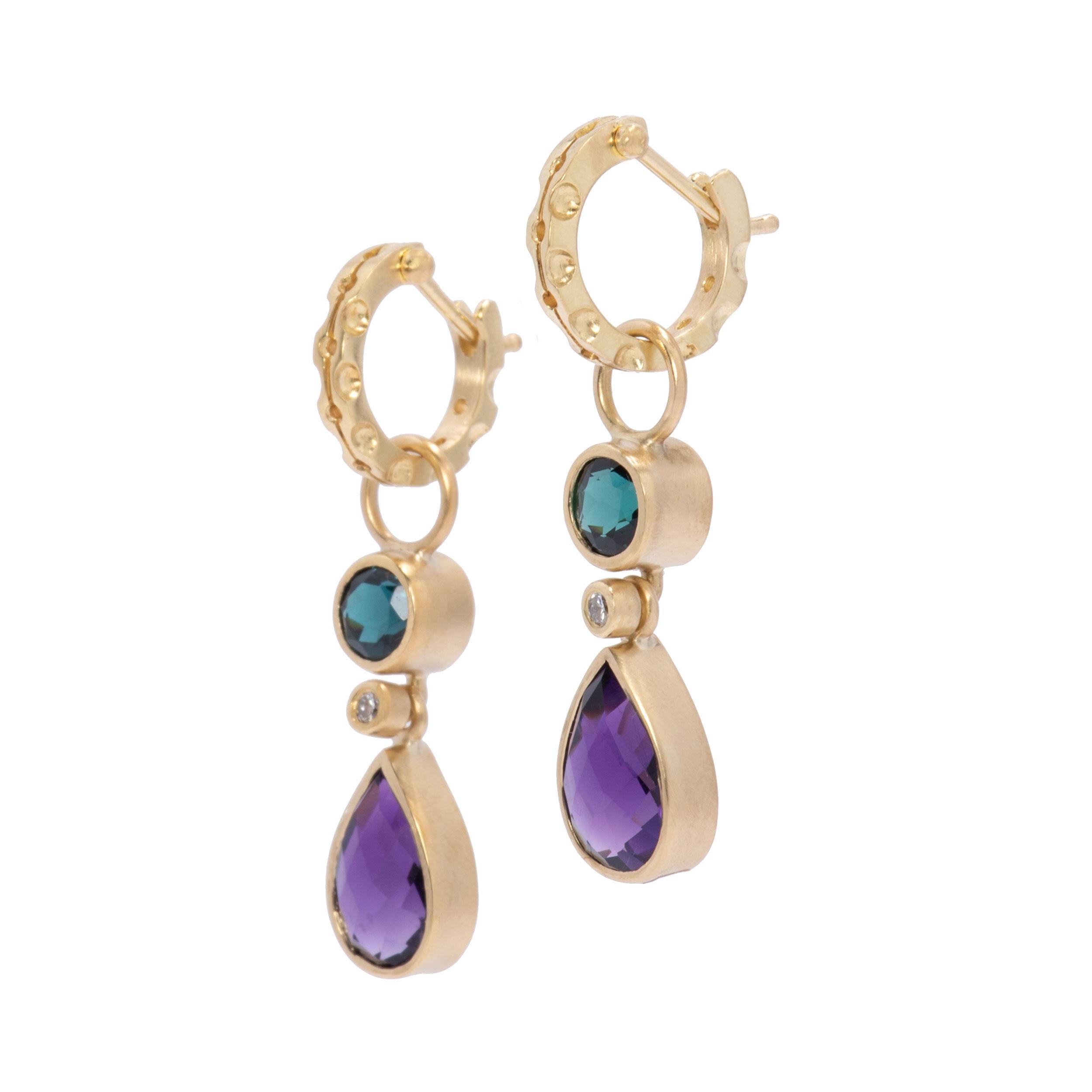 Round indicolite tourmalines 1.76cts dance above amethyst teardrops 4.74cts in pops of vibrant color. A flash of round bright white diamonds .10cts center stage ramp up the sparkle and all are set in our signature satin finished 18k gold. Suspended