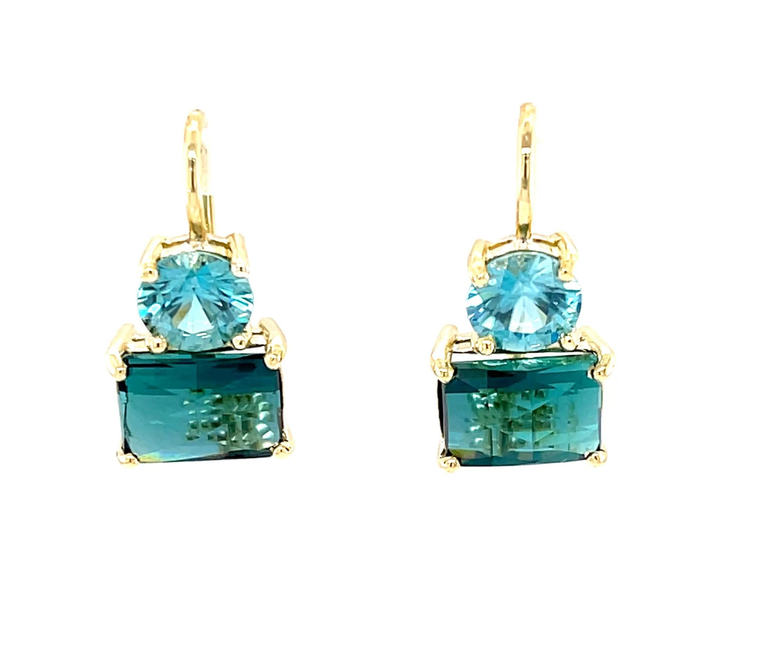 These gorgeous drop earrings feature a beautifully matched pair of stunning indicolite tourmalines combined with vibrant blue zircons set in 18k yellow gold. The indicolites weigh over 4 carats combined and have domed, triangular checkerboard tops