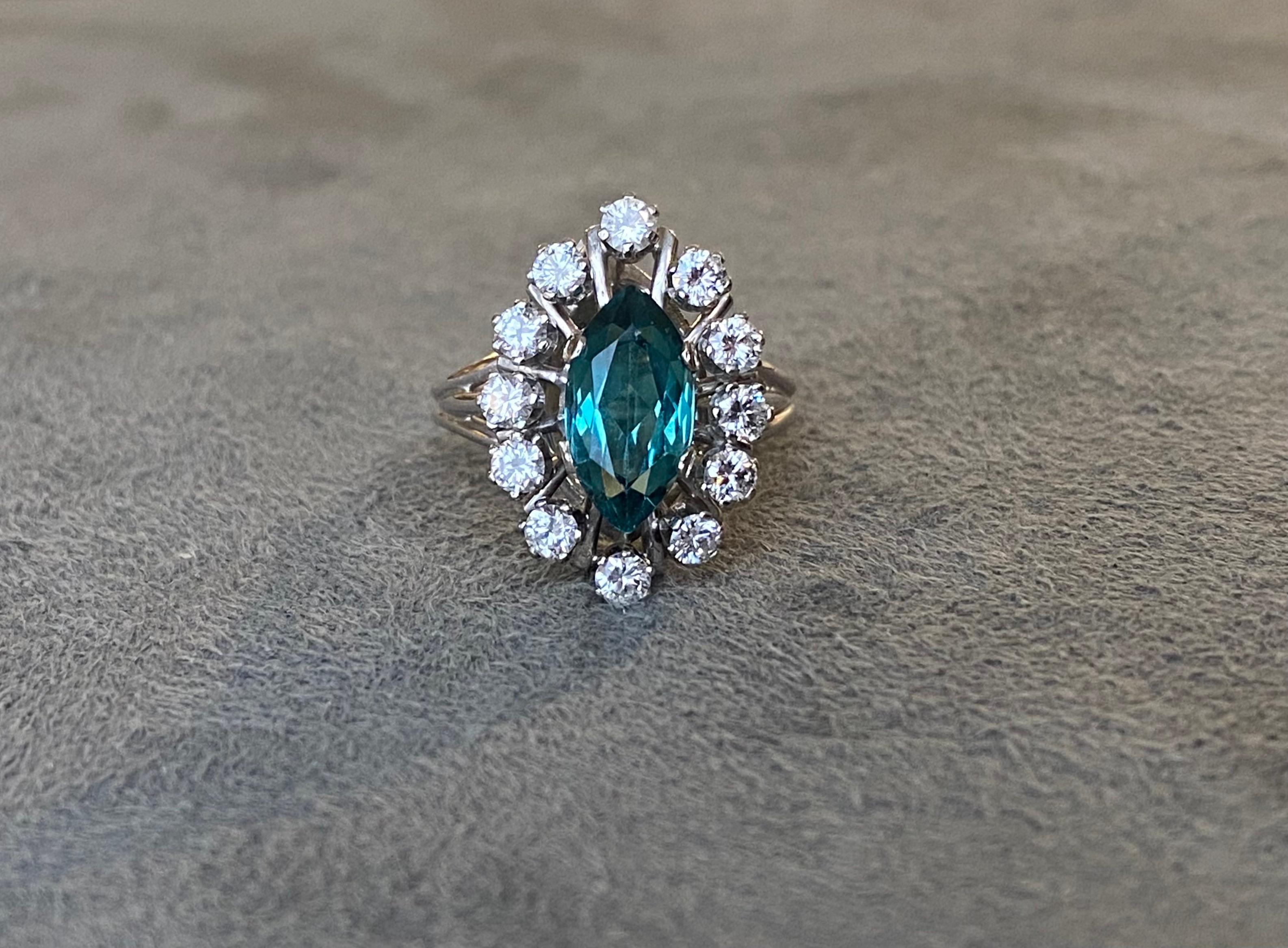 A marquise cut indicolite tourmaline (approximately 1.6 its) set with 12 brilliant cut diamonds (approximate total weight 0.75 ct) in 18k white gold. 
