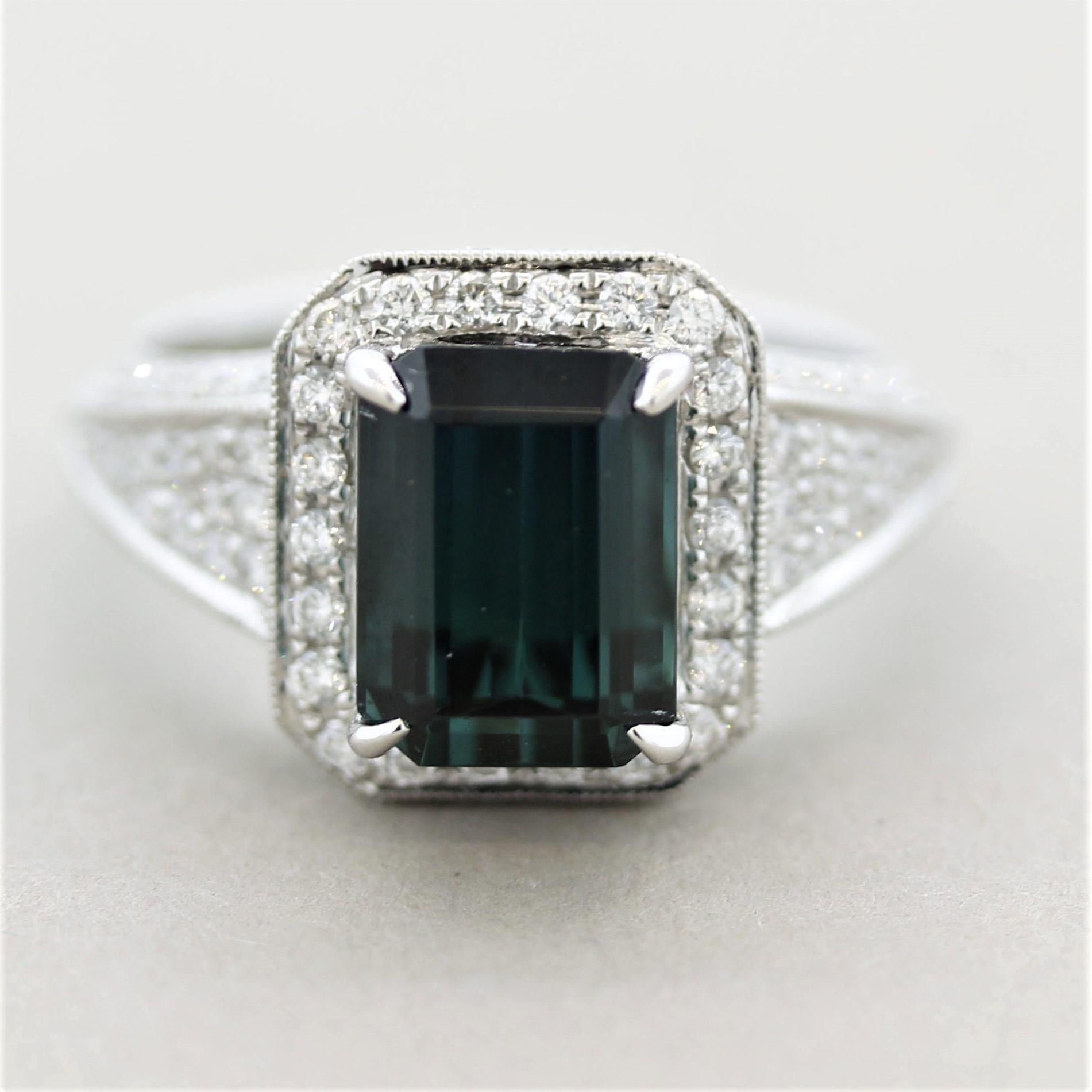 A rare and beautiful greenish-blue tourmaline known as indicolite in the trade for its unique color! It weighs 3.65 carats and has an intense steel-blue color. It is accented by 0.89 carats of round brilliant-cut diamonds set around the tourmaline
