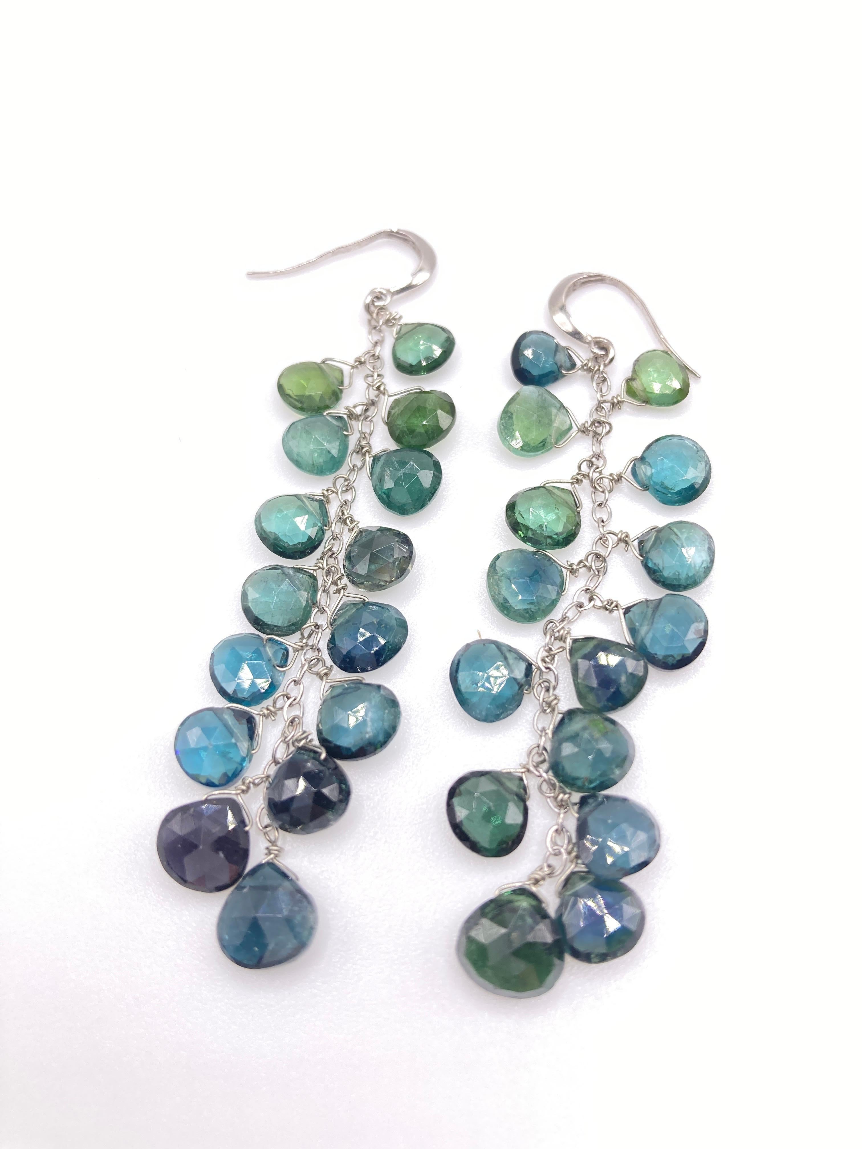 These rare indicolite cascades down from a light greenish blue to a deep blue. Very light although 2,3/4 long, you can't feel them on and won't pull down your ear lobe. They come with a safety rubber end. Also available in pink tourmaline, green