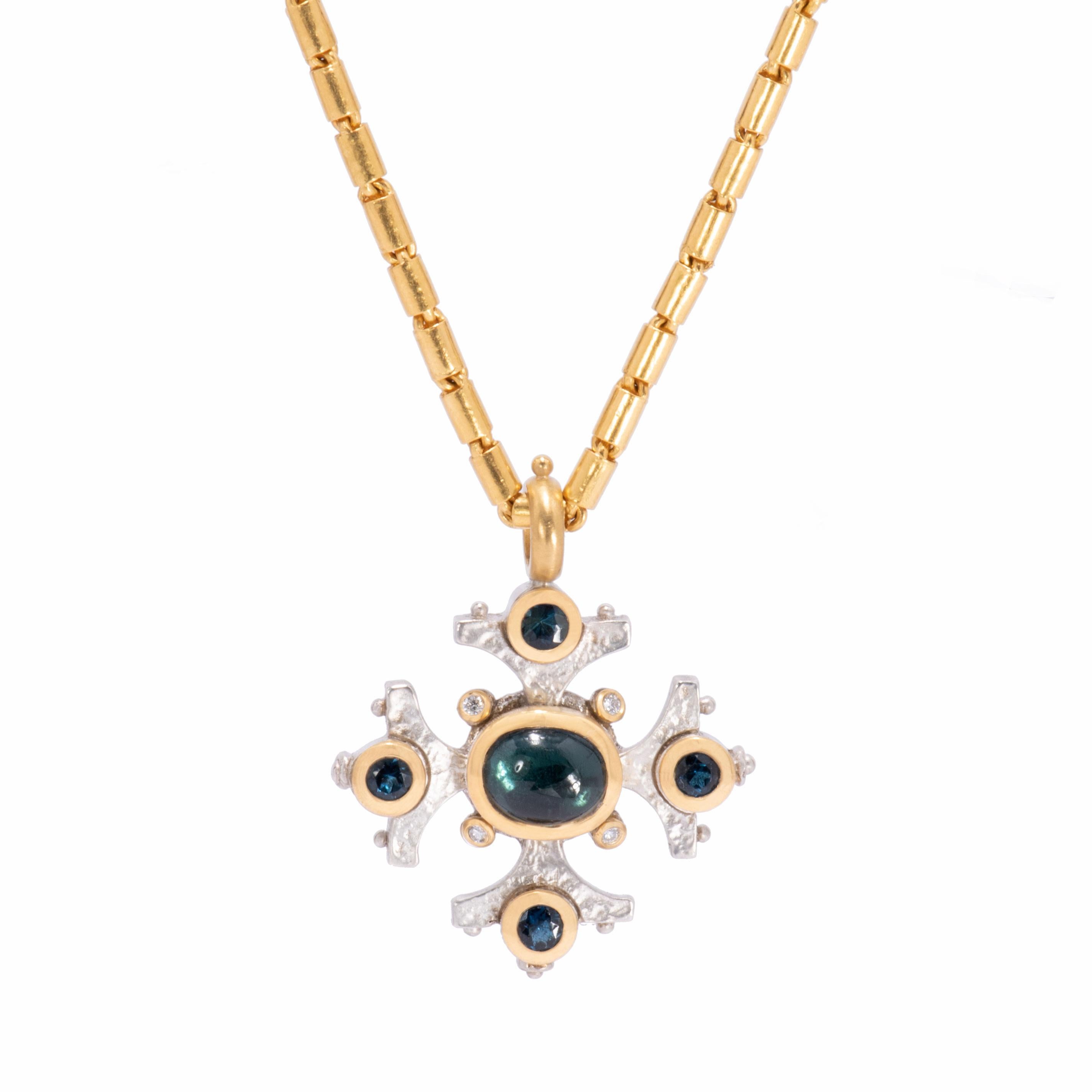 The velvety richness of blue green indicolite tourmaline speaks volumes in our mixed metal Maltese Cross Pendant. The cabochon center stone 3.39 cts. and faceted satellite stones .89 ctw. are bezel set in 22kt gold for maximum contrast against a