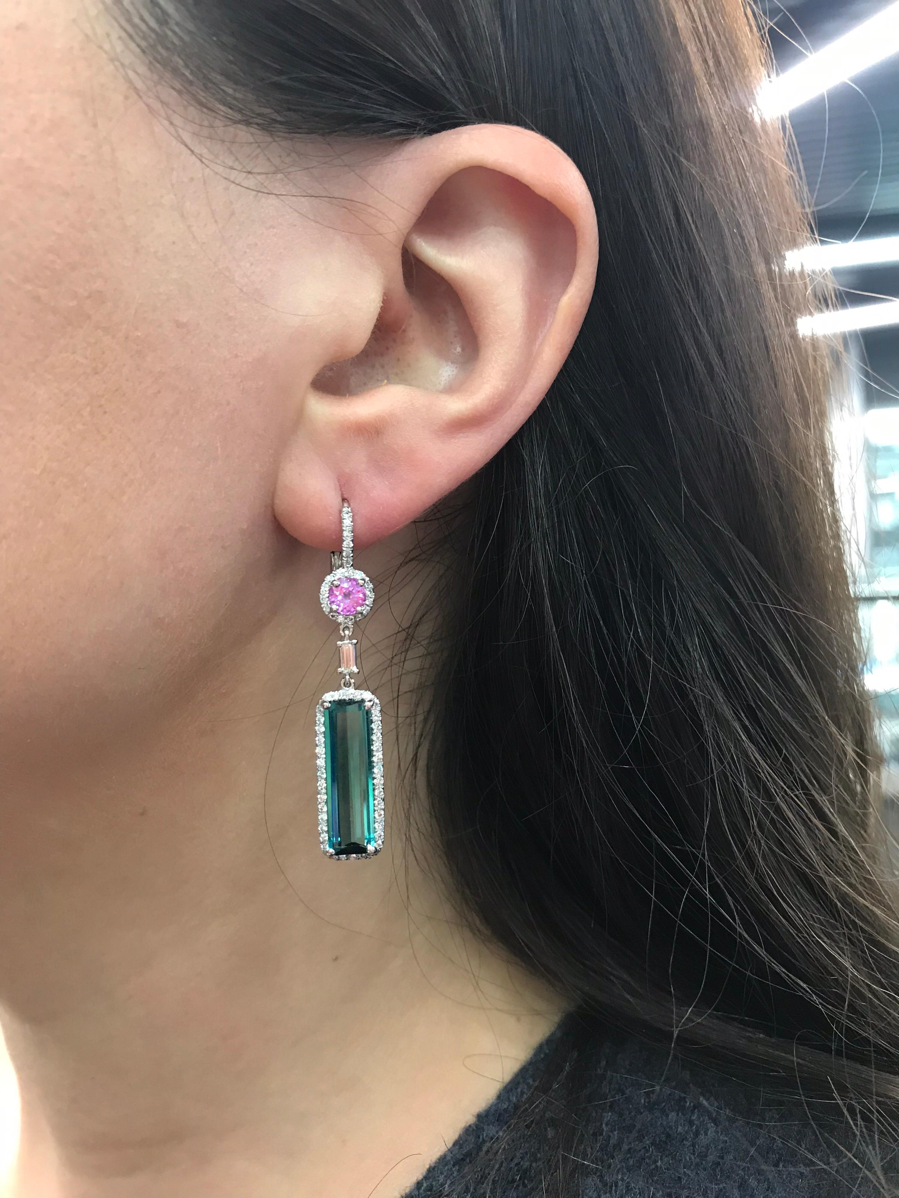 14K White gold drop earrings featuring two blue-greenish Indicolite tourmalnes weighing 8 carats, with 2 pink sapphires weighing 1.00 carat flanked with round brilliants weighing 1.10 carats.

Color G
Clarity VS-SI