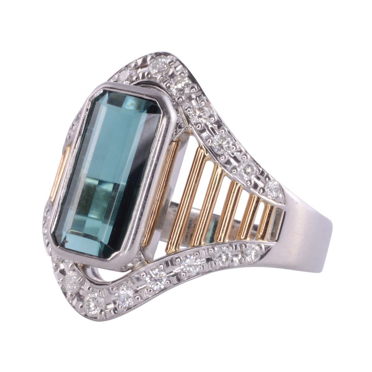 Estate American indicolite tourmaline ring, circa 2000. This 18 karat yellow gold and platinum ring features a fine quality emerald cut indicolite tourmaline at 2.75 carats. There are also 22 round brilliant accent diamonds having VS-SI clarity and