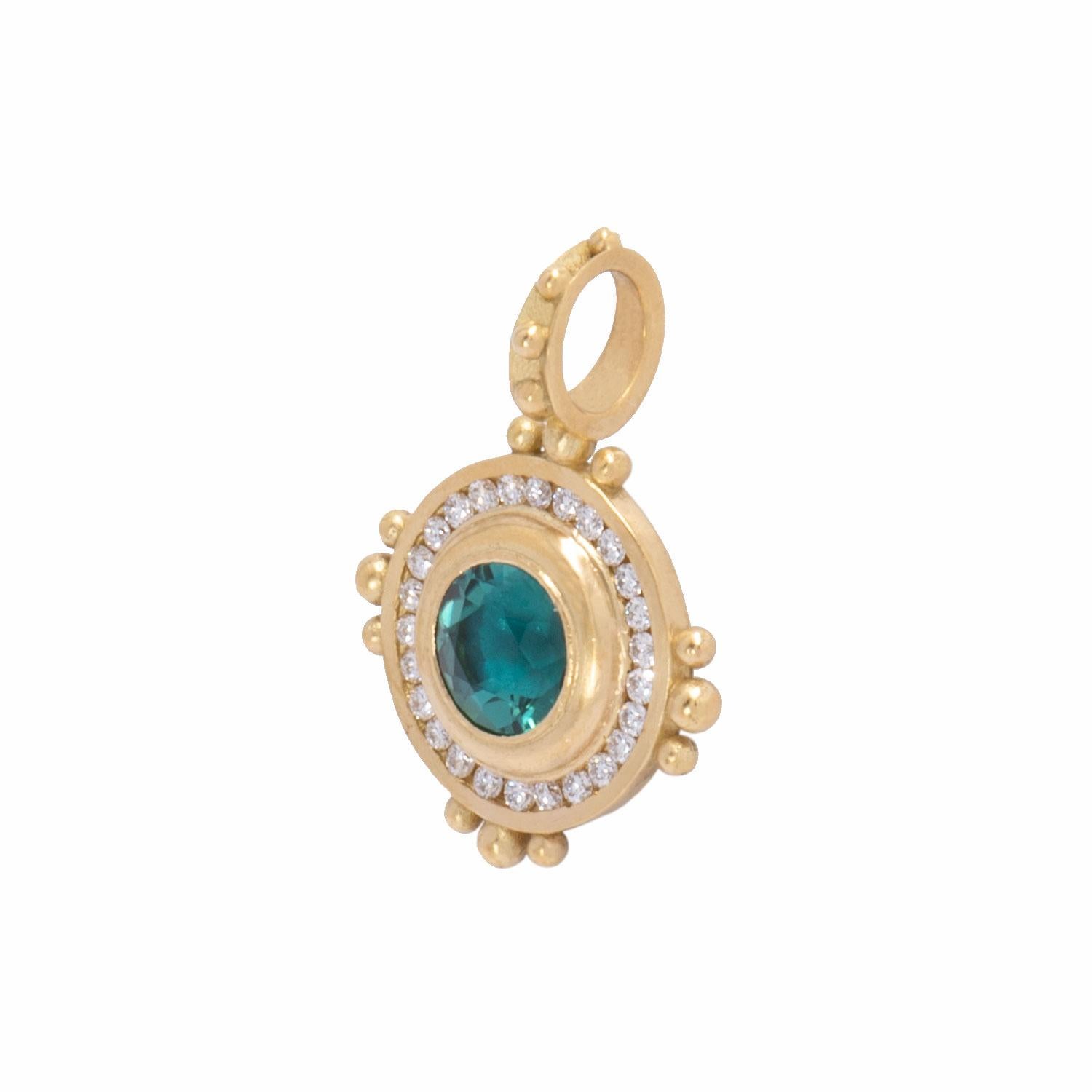 A vibrant blue green indicolite tourmaline .96cts framed in diamonds .26ctw is the focus of of the Sun Pendant. Crafted in 18k gold with our signature satin finish, the indicolite tourmaline sun pendant with diamonds is beaded at cardinal points and