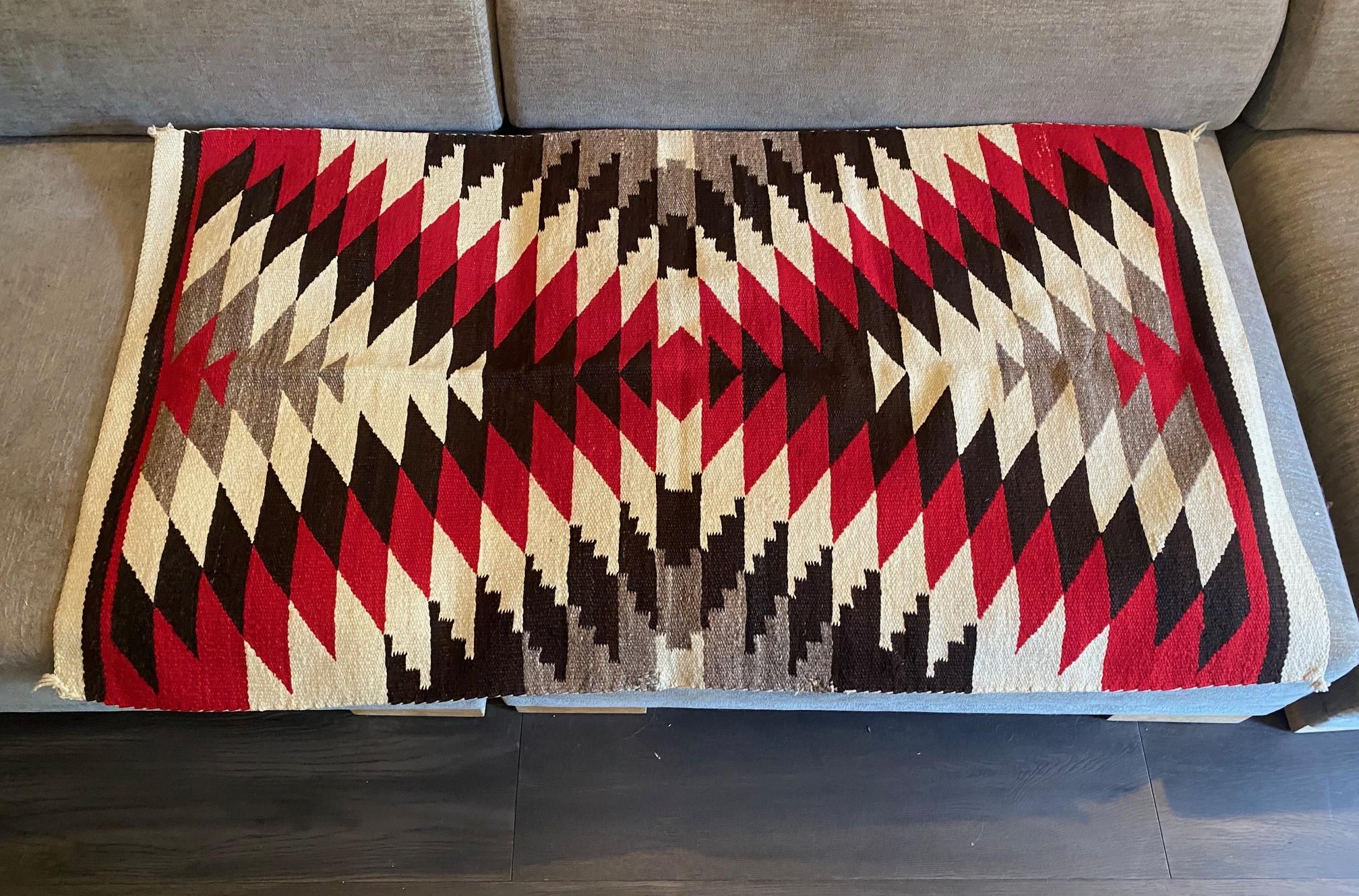 A wonderful, highly engaging, intricately hand woven antique Native North American Indian Navajo tribe wool rug/blanket featuring a geometric X-pattern (the Navajo tribe is famed for their geometric designs) and beautiful deep, rich coloring - red,