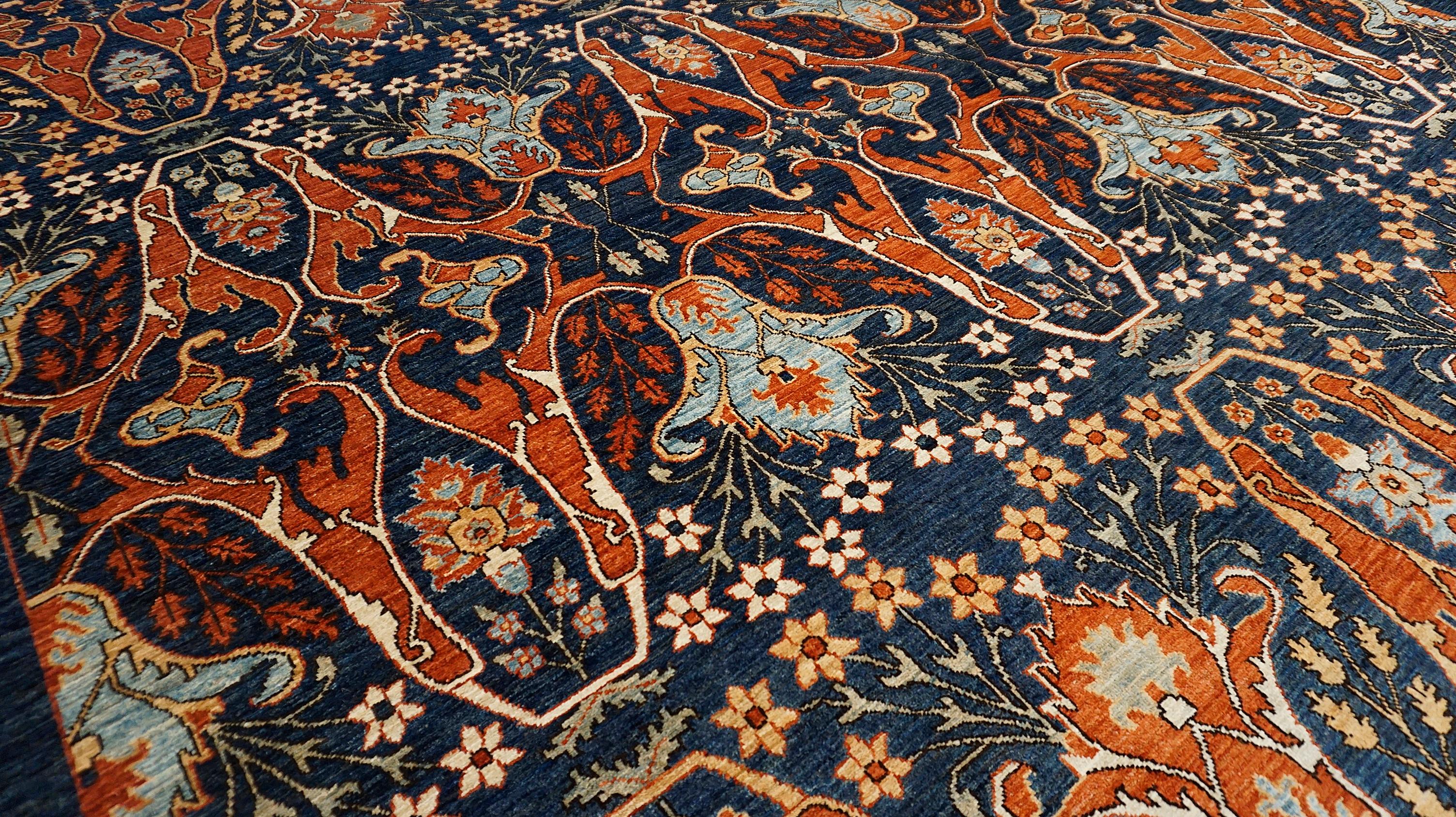This stunning 9′ × 12′ hand-knotted wool rug draws inspiration from classical Persian textile traditions, reimagined in a bold and vibrant palette. The allover layout features an elaborate lattice of stylized palmettes, boteh motifs, and lotus