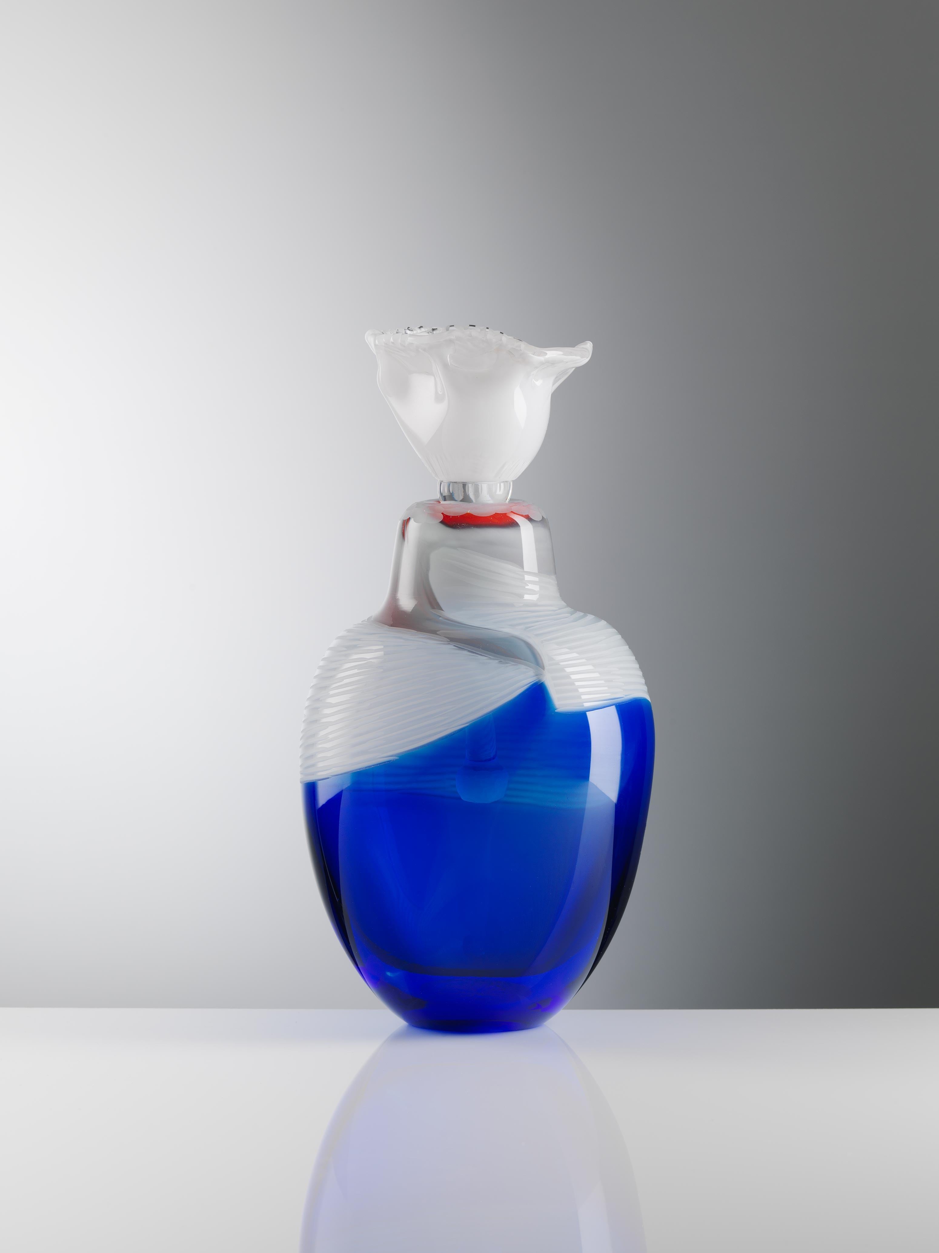 Indigo Solace4 sculpted blown glass vase handmade by Juli Bolaños-Durman
Solace Collection 2016 - 2017
One of a kind
Dimensions: 12.6 x 6.3 x 6.3 inches
Materials: Found & blown glass with cuttings

This piece is made of two parts: stopper and