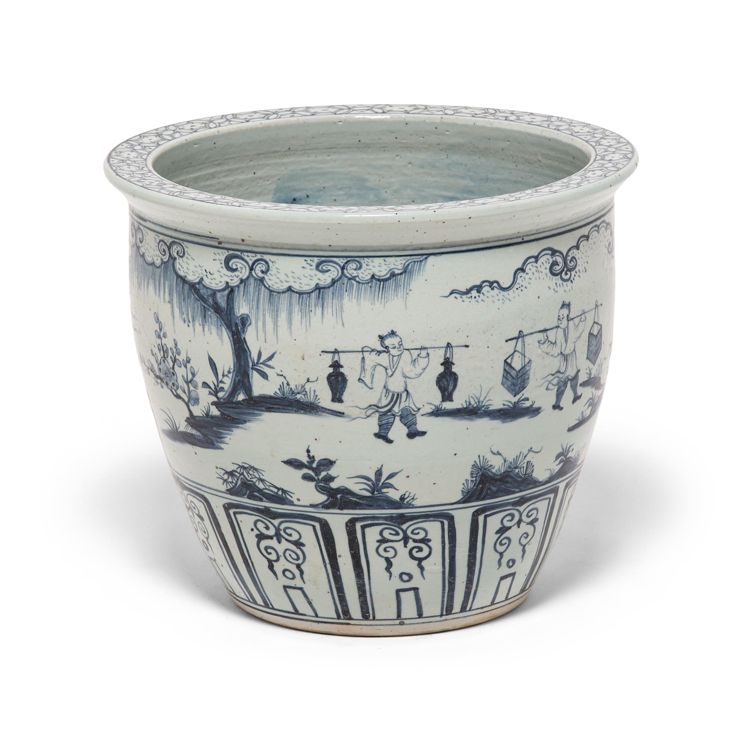 This charming blue and white scroll jar speaks to an era and way of life long gone. With unique scale and a wide mouth, this contemporary jar resembles the vessels used to store and display painted scrolls in a Qing dynasty scholar's studio. The