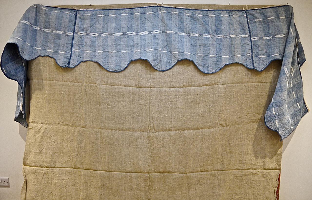 19th century French cotton flamme/ikat pelmet, originally for use round a four poster bed. On one side there are two variations of the flamme design, while the reverse has faded to a very pretty soft shade of indigo. Quilted in a simple diamond