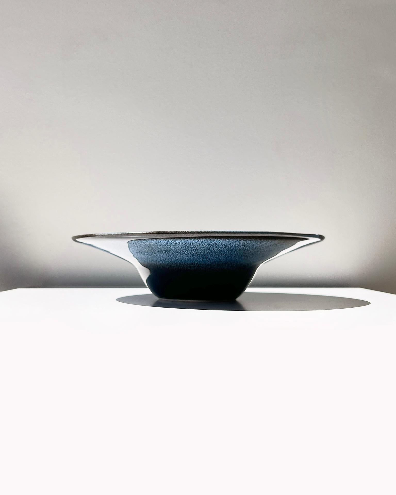 An elegant bowl to serve your favorite paella. This Anna Indigo Handmade Serving Bowl adds a touch of elegance to any dinner party or everyday meal. Each bowl is handmade in a modern Spanish style, with a unique blue and white indigo glaze. Use it