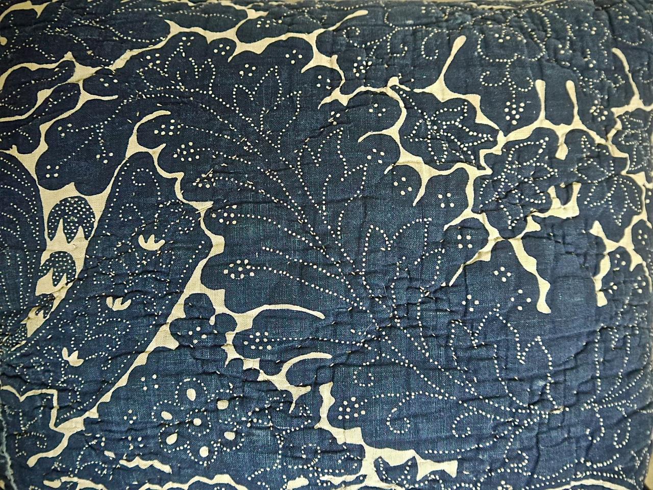 French indigo resist block printed cotton cushion probably from Rouen in Northern France. A striking design of arching acanthus leaves and stylized floral and leaf motifs. Simply quilted and backed in a dyed 19th century French linen. Slip-stitched