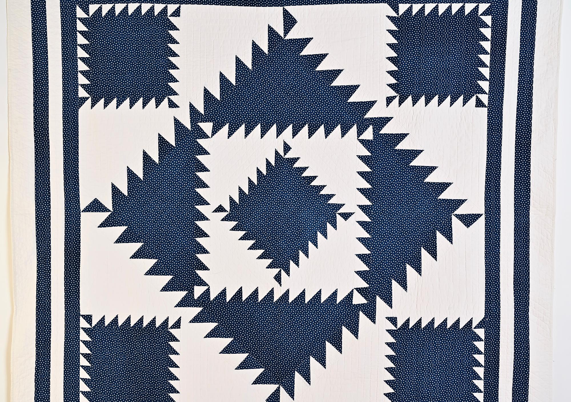Bold and striking Sawtooth Diamond quilt in one of the most desirable color combinations of indigo and white. The central pattern is framed by four sawtooth squares, an unusual touch. Four borders also add to the strength of the design. Everything