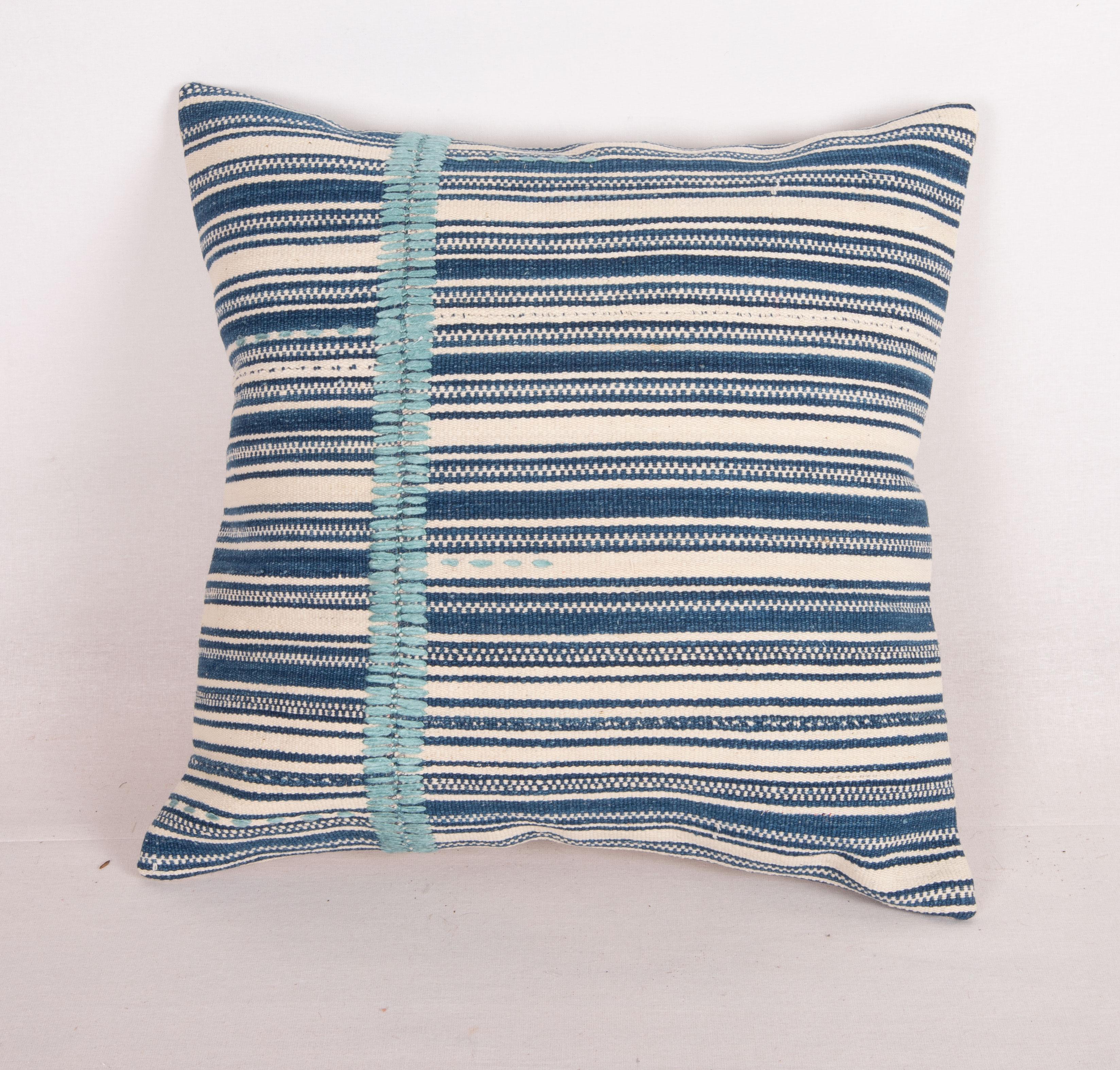 This pillow made from a cotton kilim with indigo stripes. 
The hand stitching is done recently by hand , in silk.
It does not come with an insert.
Linen in the back.
Zipper closure.
Dry Cleaning is reccommended.