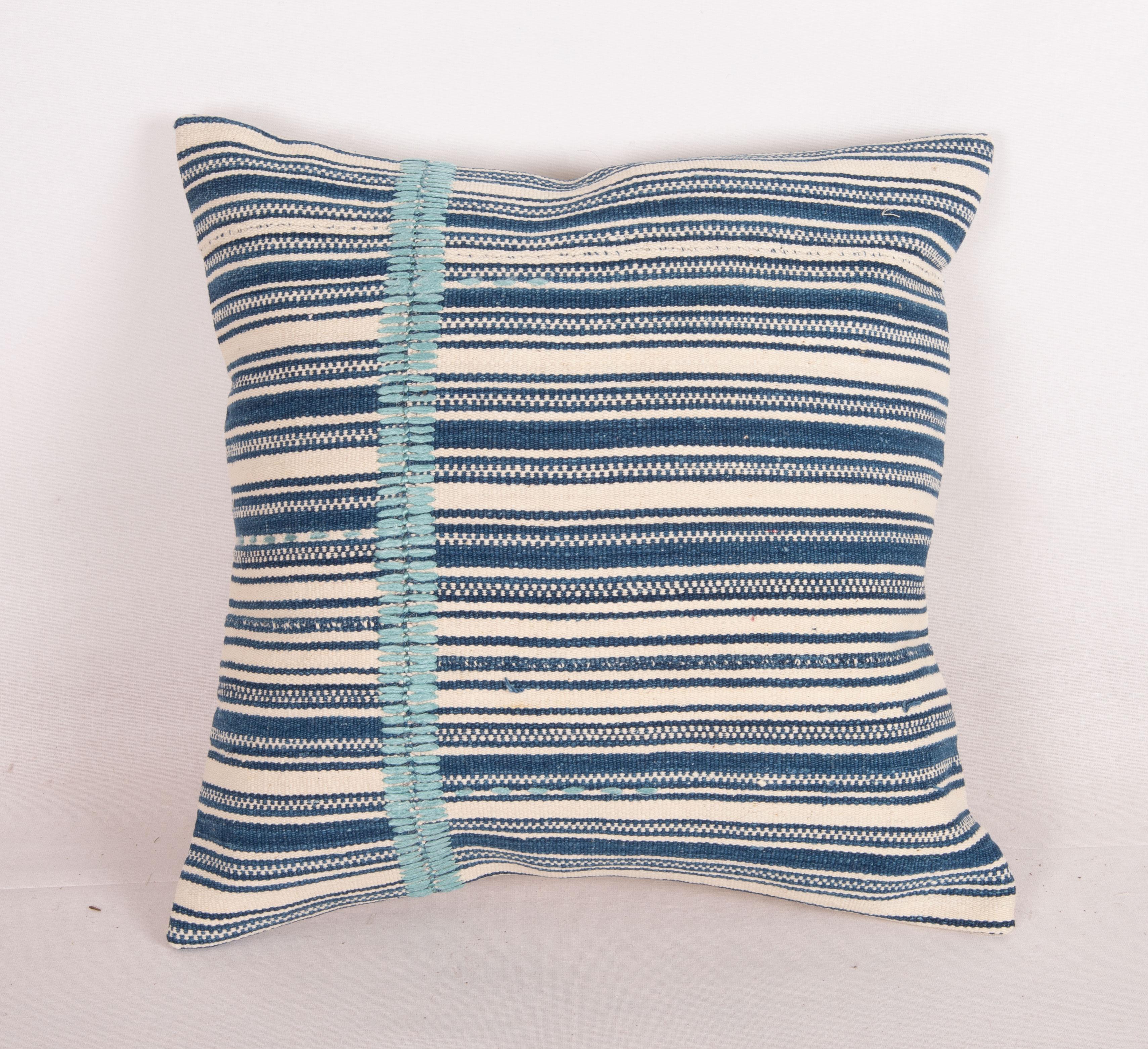 This pillow made from a cotton kilim with indigo stripes. 
The hand stitching is done recently by hand, in silk.
It does not come with an insert.
Linen in the back.
Zipper closure.
Dry Cleaning is reccommended.
 