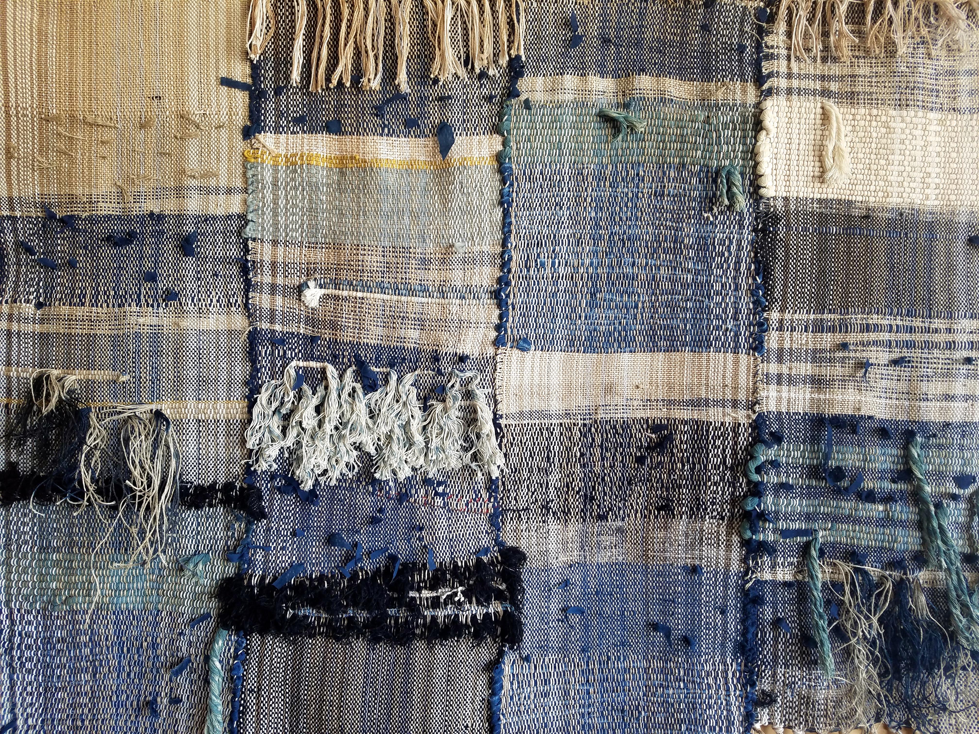 Handwoven wall hanging by Janelle Pietrzak of All Roads. Shades of indigo, navy blue, cream and black. This piece is multiple woven panels hand-stitched together to make one piece. 

Fibers used are cotton, linen and wool weaving hangs from a steel