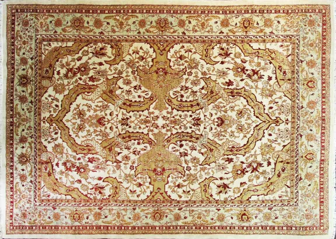 A classical design of swaying palmettes and tendrils emanates from a central blossom. The consistent tone-on-tone coloration gives the entire composition a remarkable decorative unity. Simply put, this rug is a remarkable piece of work and very