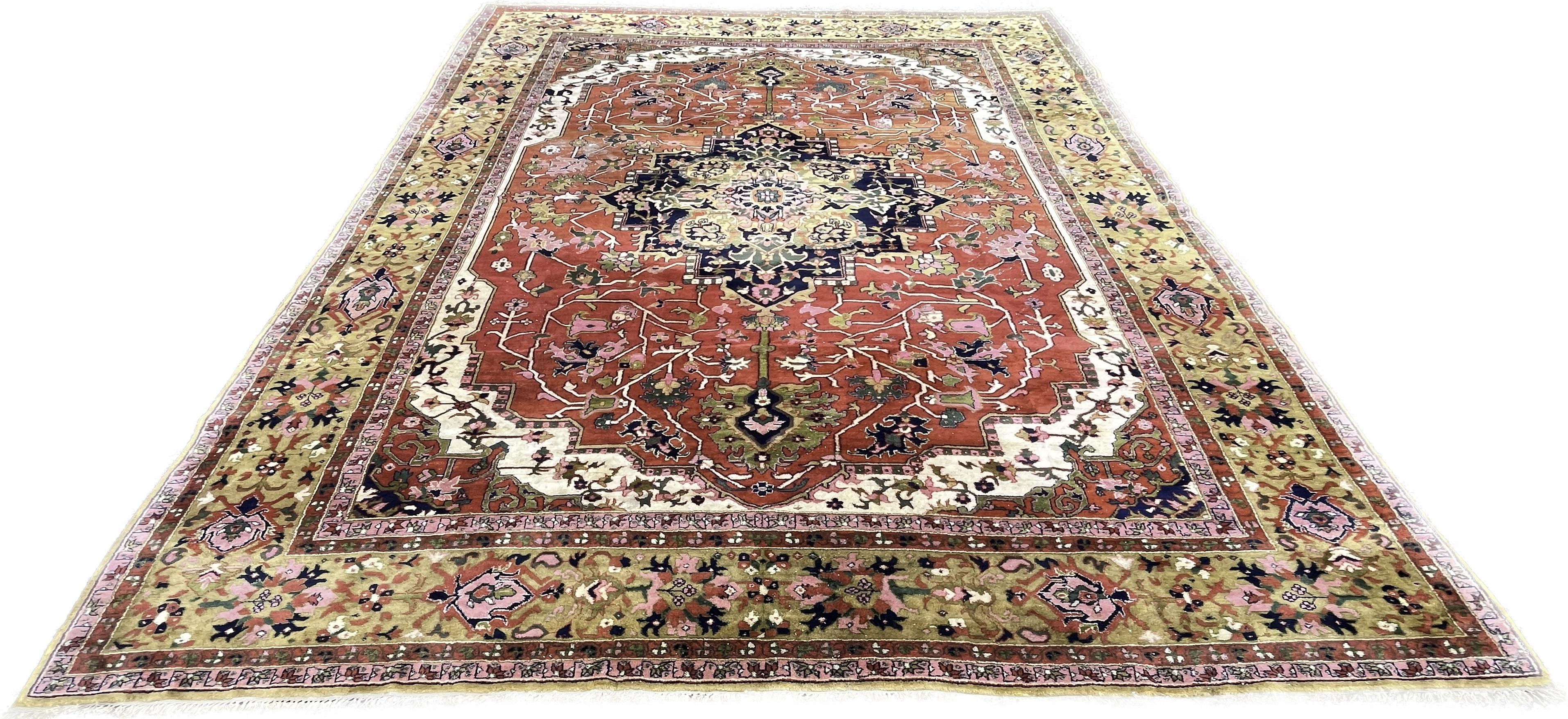 Modern rug in the style of Hériz, hand-knotted in India around 1940.

The many bright colors chosen for this piece are designed to contrast with each other, drawing attention to their shape and composition.
In the center of the rug, a geometric