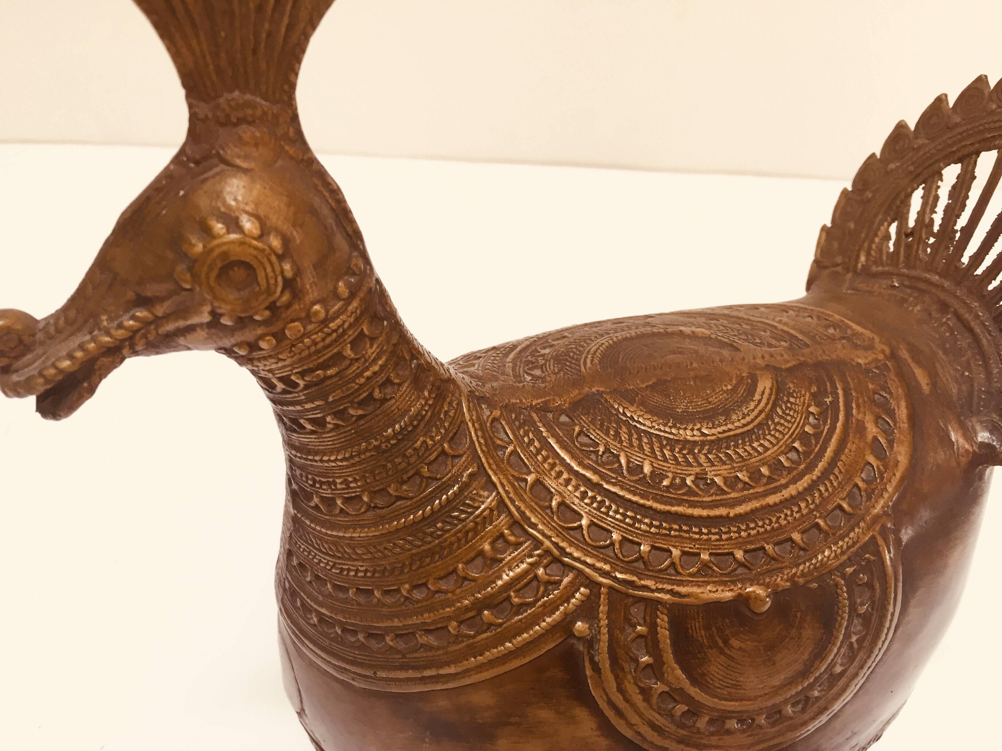 Handcrafted Indo-Islamic decorative collectible copper betel nut bird shape trinket box.
Large tribal-style heavy brass bird box.
Beautiful handcrafted large folk art style heavy bird form box with lid, latch and handle.
Delicately and intricately