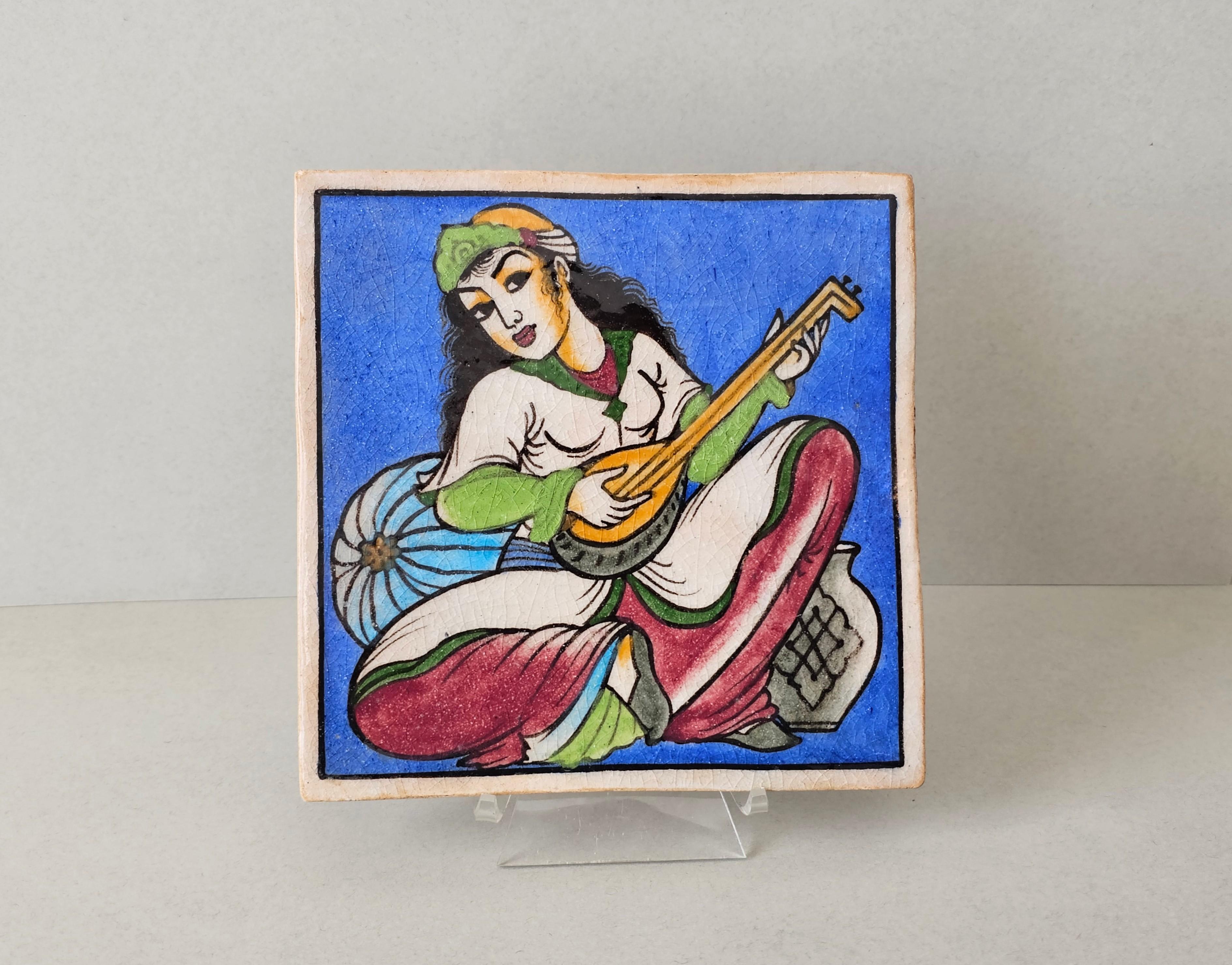 Exquisitely hand painted ceramic wall tile, Indo-Persian, late Qajar dynasty (1789-1925), exceptionally executed beautifully colored artwork depicting woman playing the oud.

Provenance:
From the estate of Margaret 