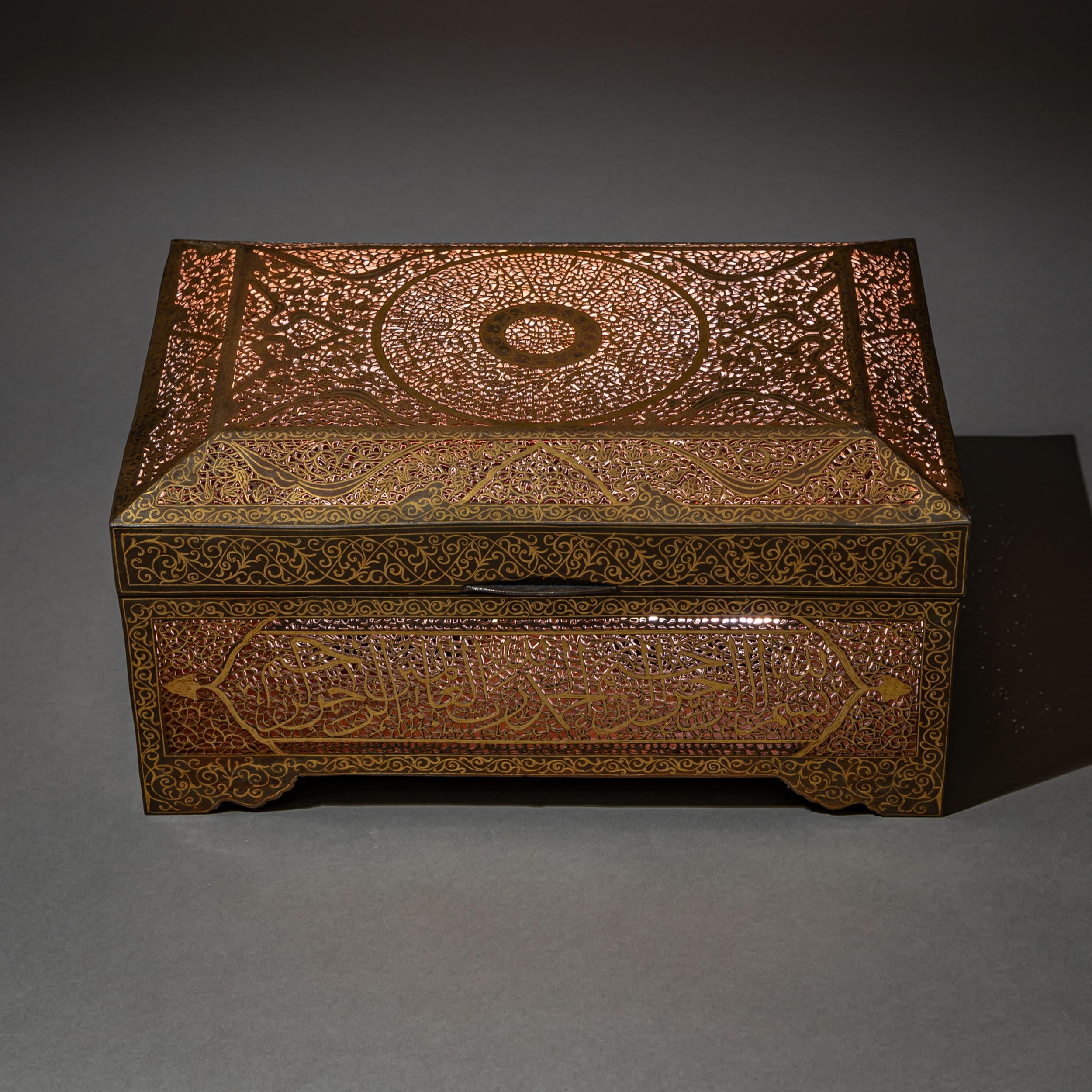 Exceptional Indo-Persian iron casket intricately decorated using the Koftgari technique—fine gold wires hammered into the iron surface. Adorned with delicate Arabic calligraphy, the box was originally intended for storing a Qur’an.
Originating from