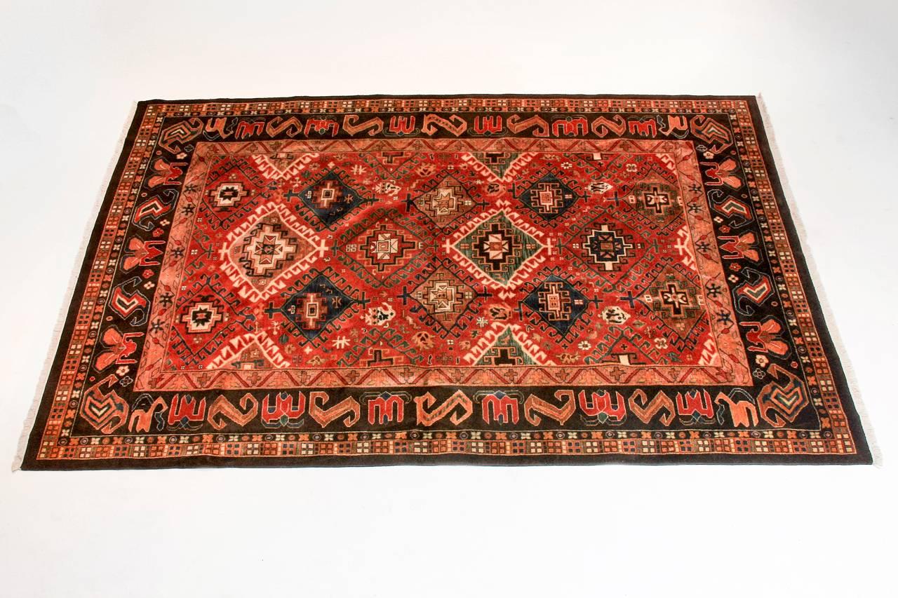 Remarkable Indo-Persian carpet made in the Shiraz style with a modern tribal design. Features geometric diamond pattern field over a brown colored ground. Multiple banded border with interesting designs.