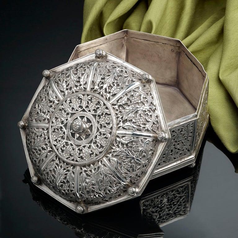 A very rare Indo, Portuguese silver octagonal box, Goan, 17th century, profuse pierced decoration with floral motives and exotic birds, approximate measures: 5 inches in height and 6 1/4 inches in diameter, the weight 24ozs approximate.