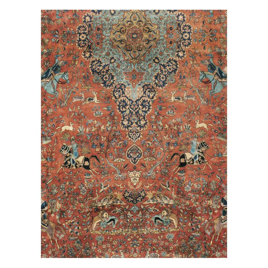 A vintage Indo-Tabriz pictorial carpet handmade during the mid-20th century in the style of the famous silk 'Hunting Carpet' in Vienna woven in Persia during the Safavid Era.

Measures: 11' 11