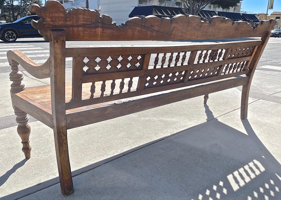 Indonesian 19th Century Hand Carved Teak Garden Bench with Two Side Arms In Distressed Condition In Santa Monica, CA