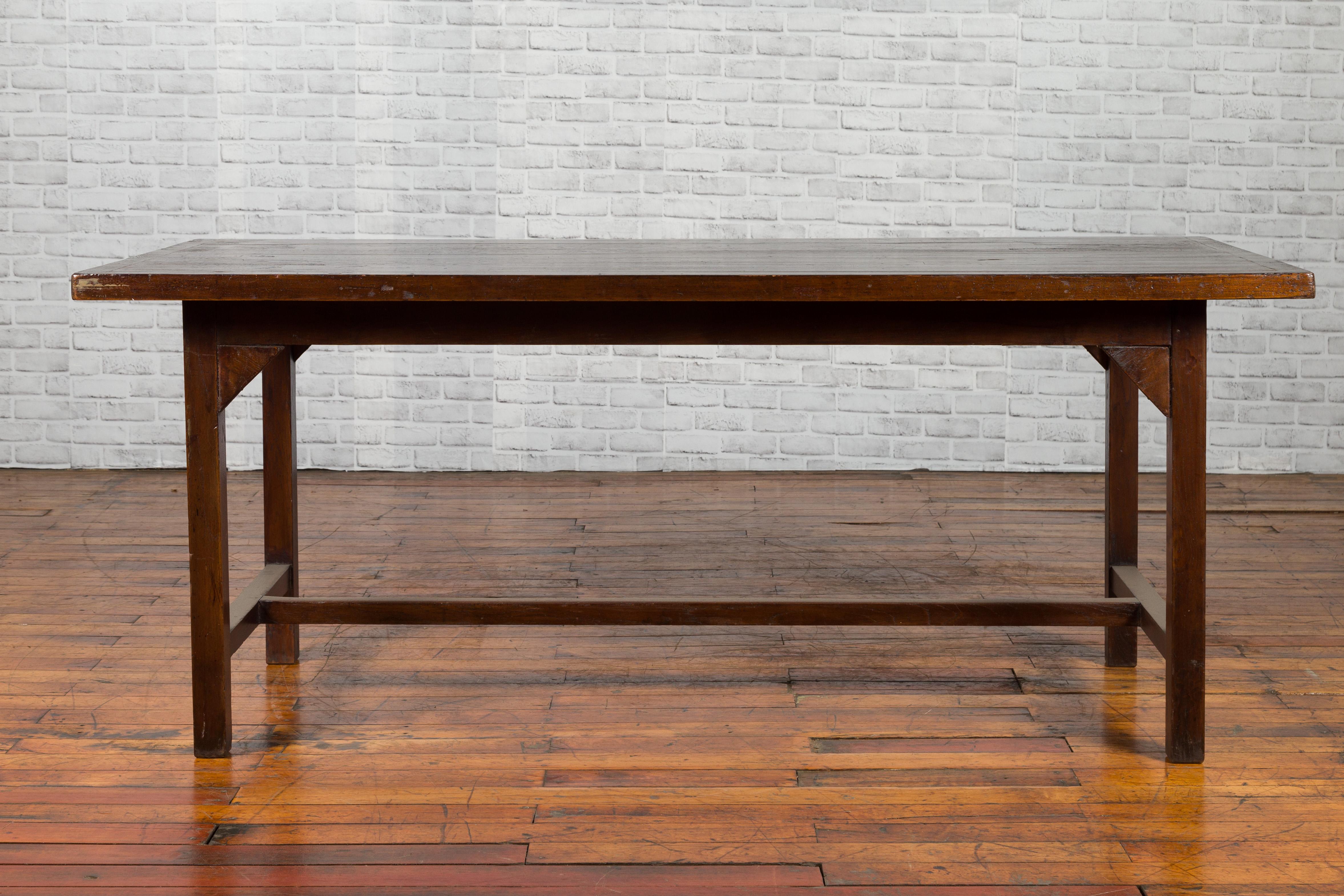 Wood Indonesian 20th Century Table with Dark Brown Patina and H-Form Stretcher