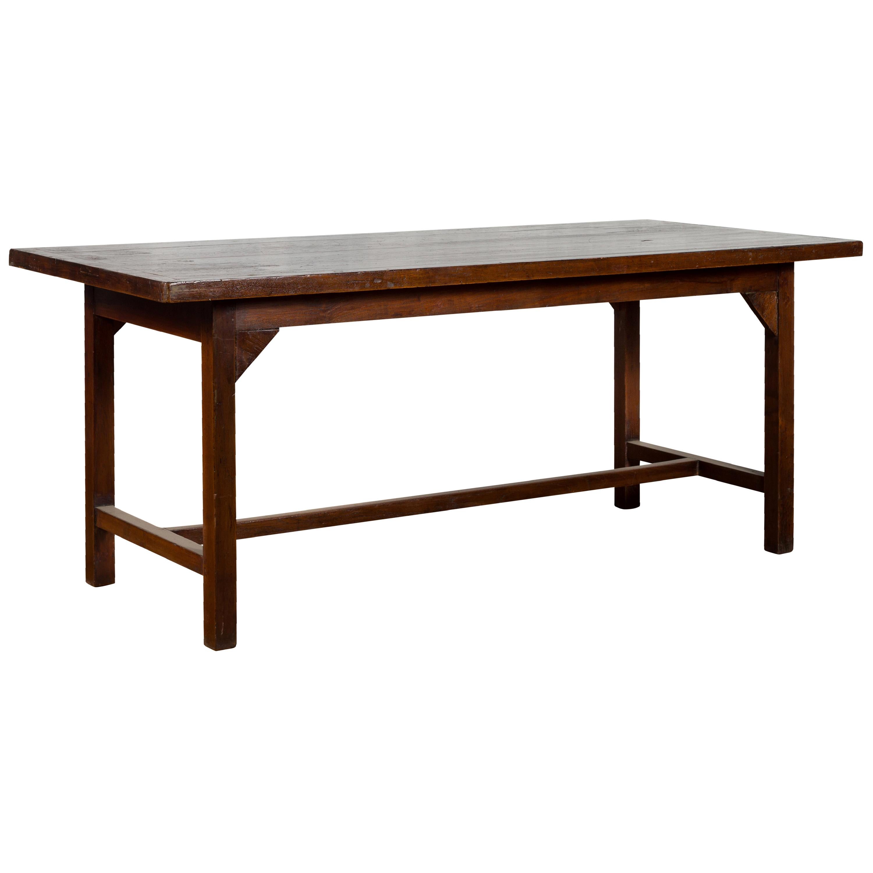 Indonesian 20th Century Table with Dark Brown Patina and H-Form Stretcher