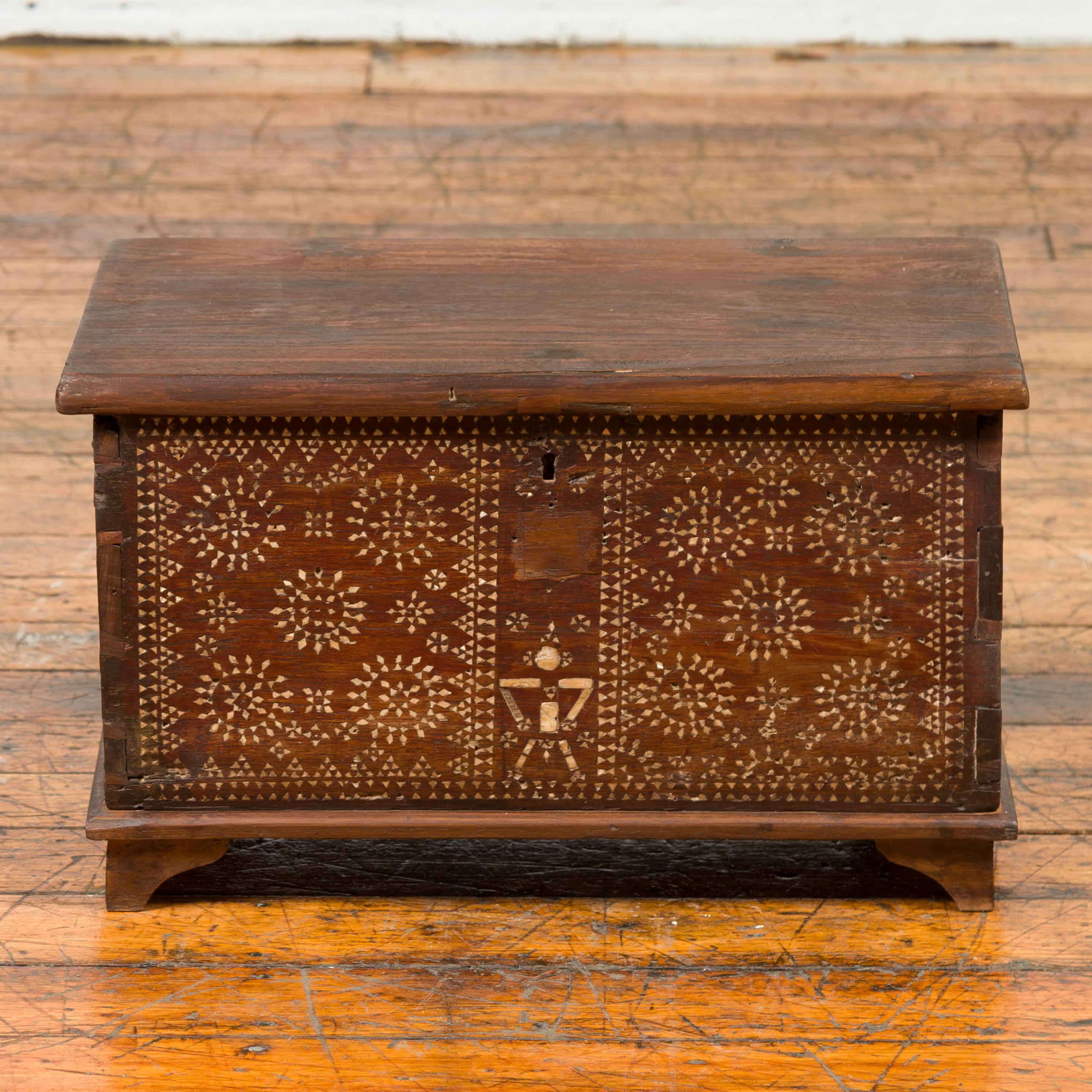 An antique Indonesian blanket chest from Madura, with geometric mother of pearl inlay. Born on the island of Madura off of the northeastern coast of Java, this exquisite blanket chest attracts our attention with its skillfully inlaid mother of pearl