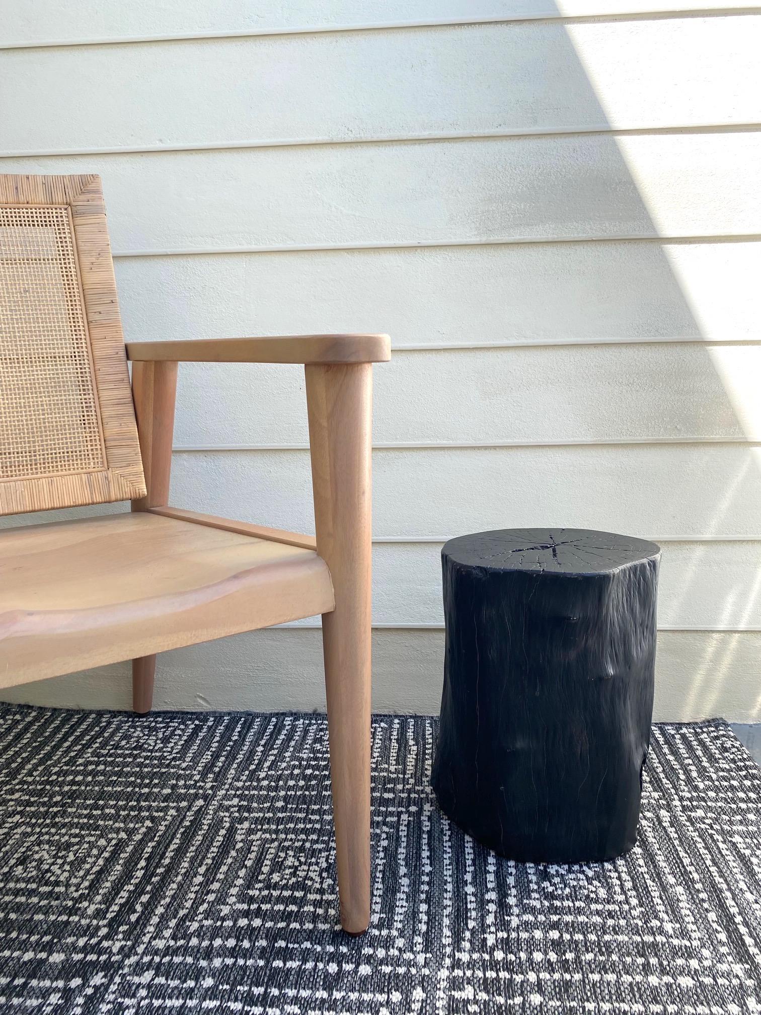 Indonesian burnt and blackened teak wood stump with organic modern design. Makes a gorgeous accent piece for a bathroom or can be used as a drink table or side table. Excellent condition with minor natural variations of lighter wood tones