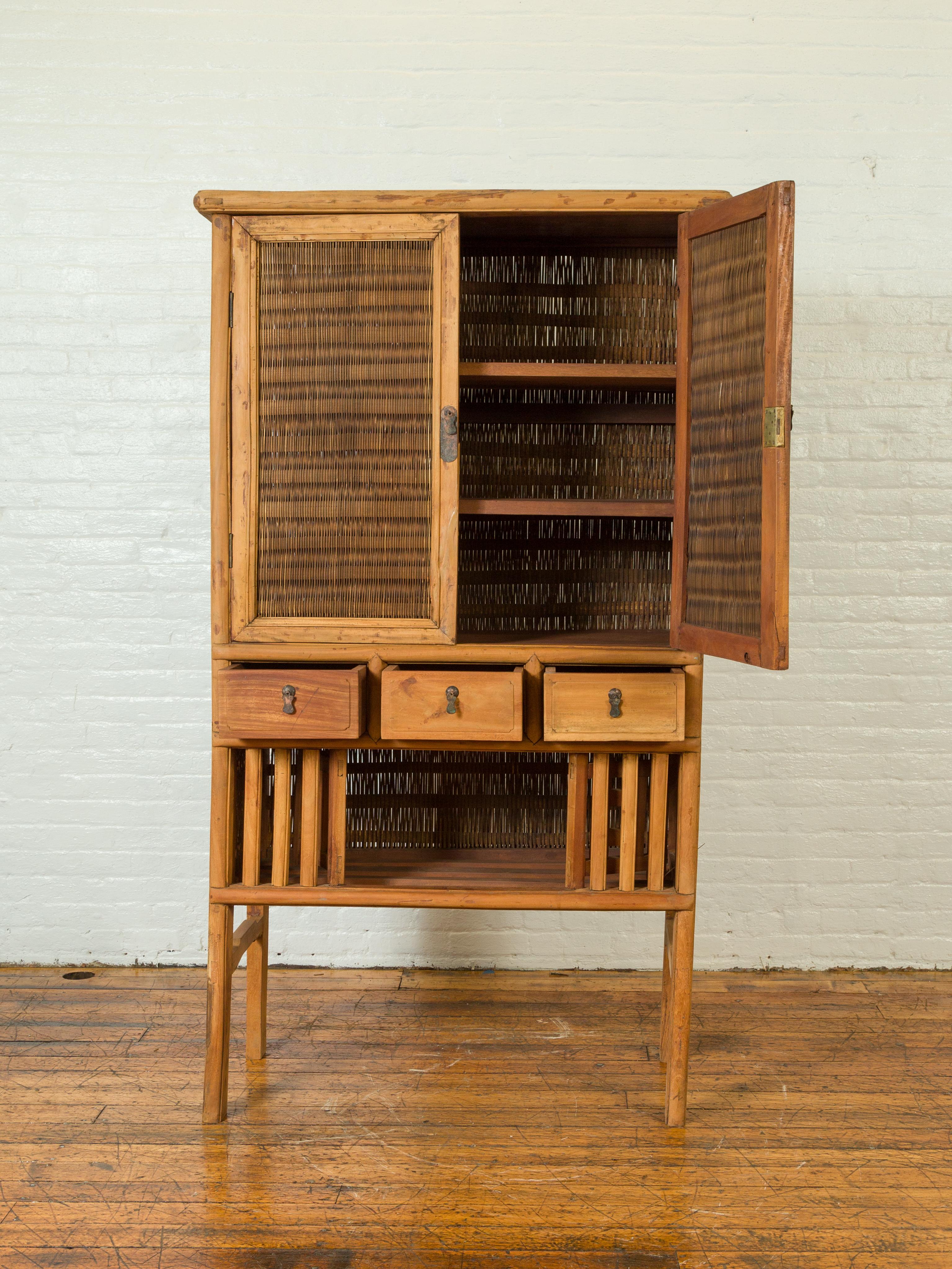 Indonesian Cabinet With Rattan Doors Drawers And Fretwork Sliding