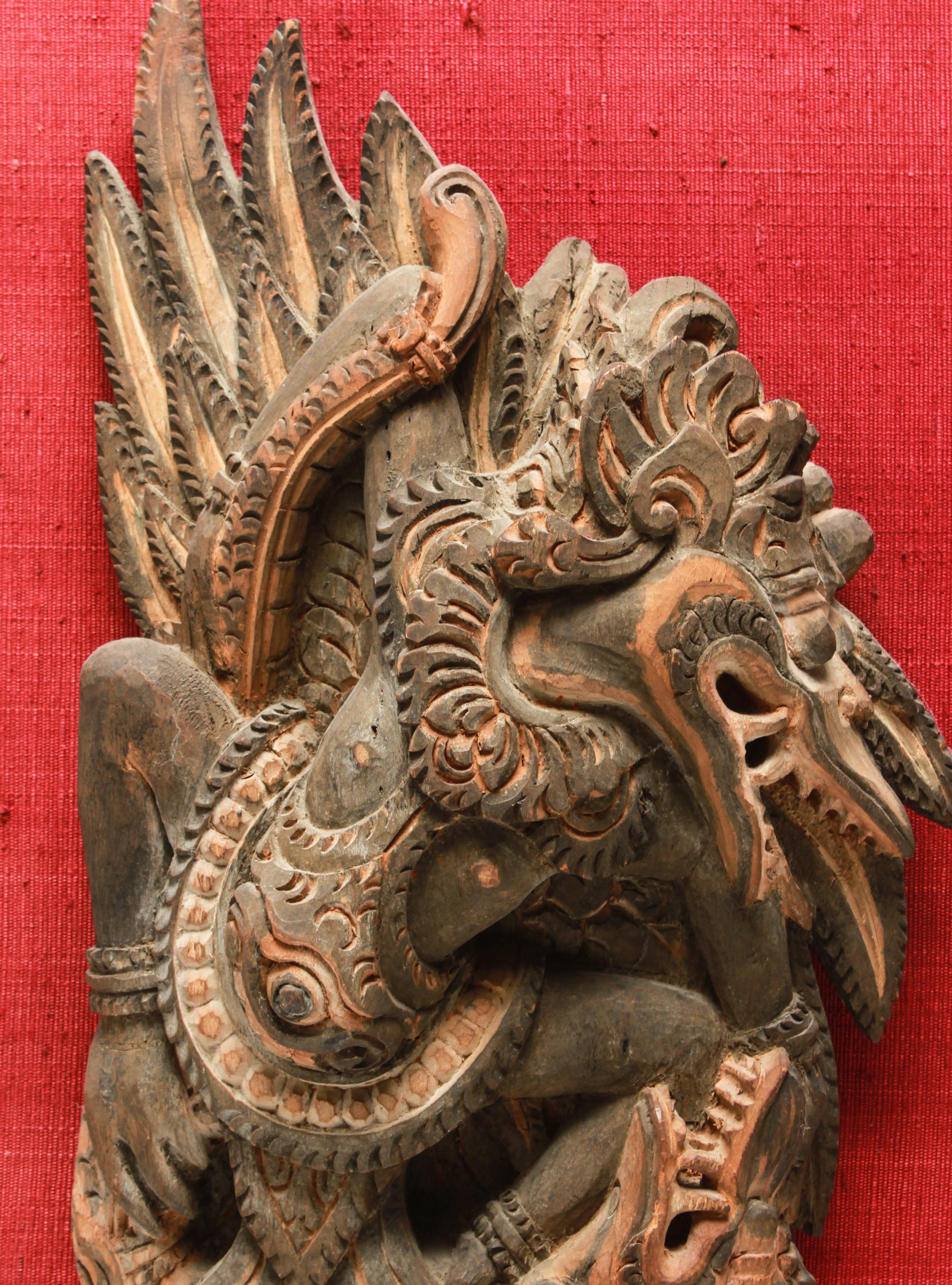 Indonesian Balinese wood hand carved Garuda bird sculpture, mounted as a wall hanging. The sculpture itself is 14.75