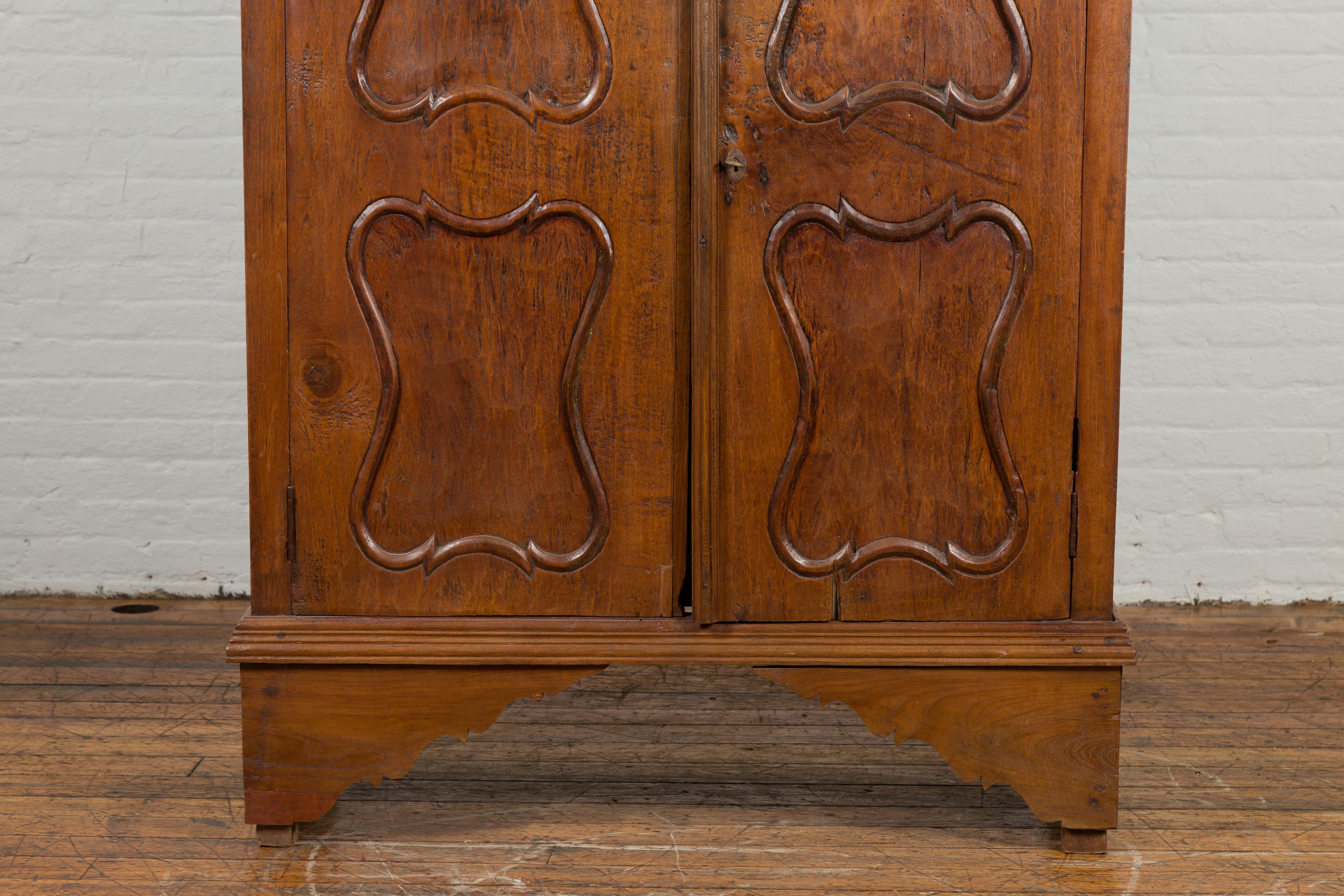 Indonesian Early 20th Century Carved Teak Wood Cabinet with Molded Cartouches For Sale 4