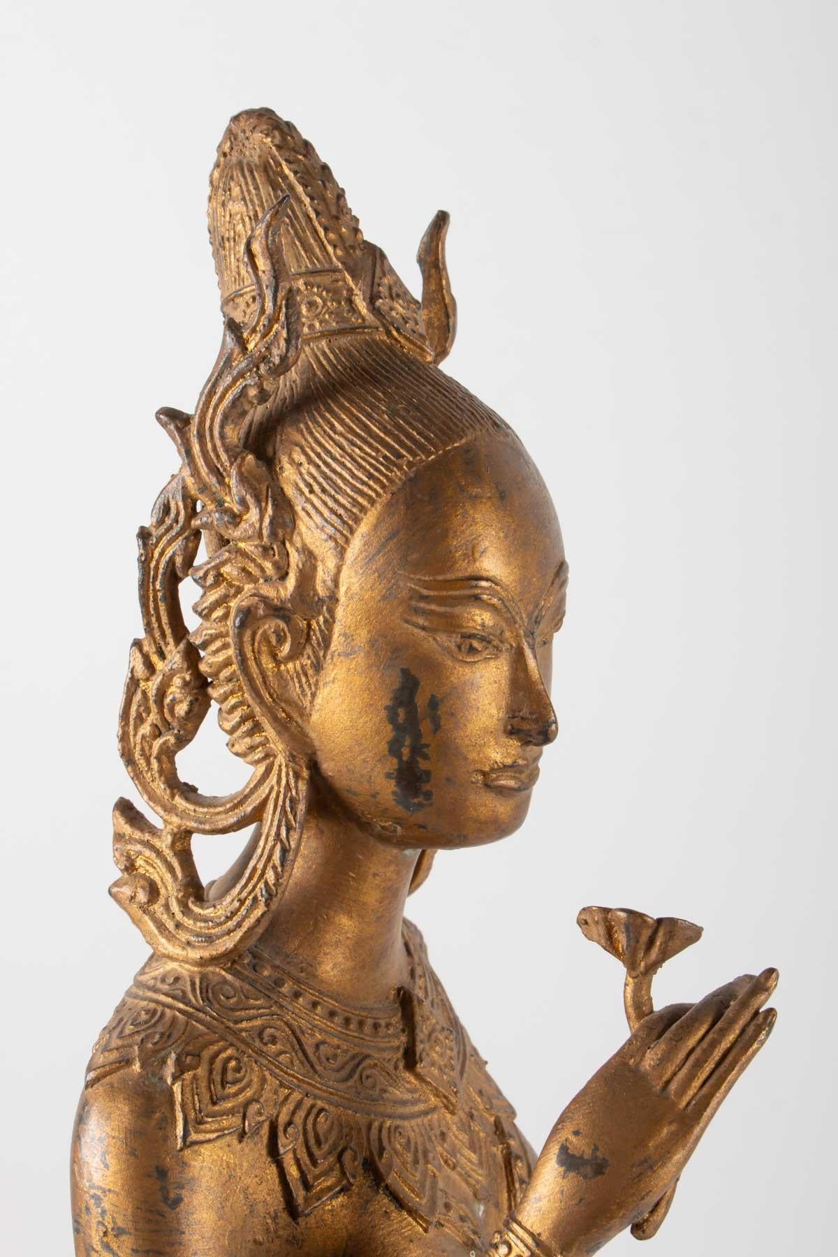 Chinese Export Indonesian Goddess in Gilded Metal Holding a Lotus Flower, 1920-1940 For Sale