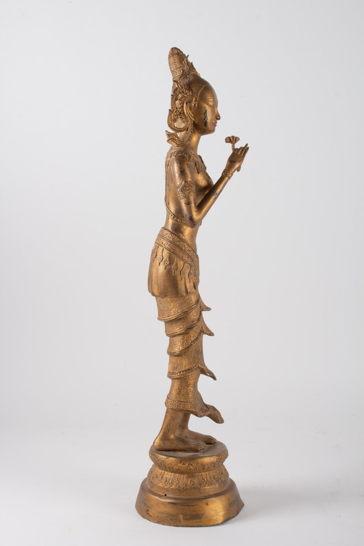 Asian Indonesian Goddess in Gilded Metal Holding a Lotus Flower, 1920-1940 For Sale