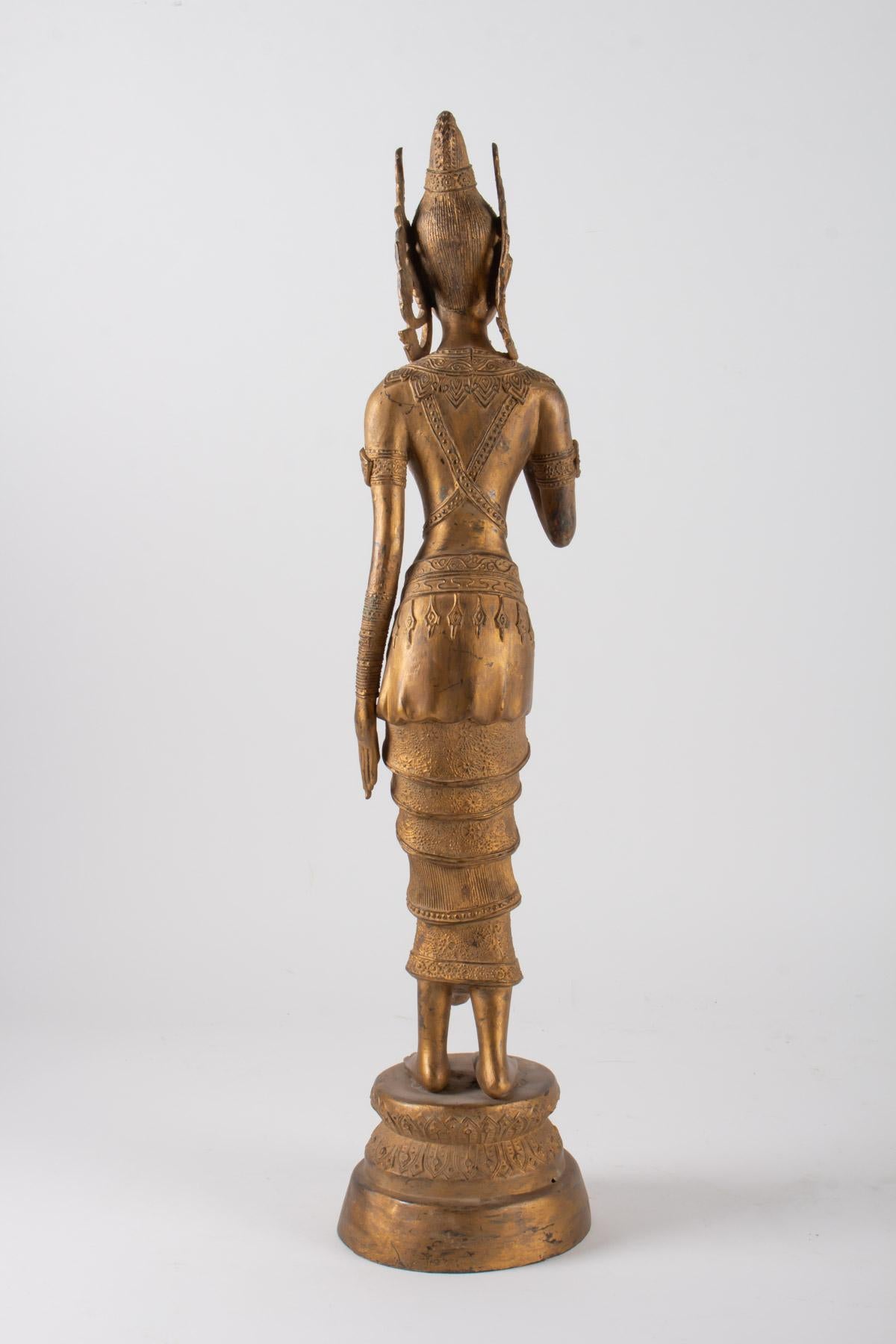 Gilt Indonesian Goddess in Gilded Metal Holding a Lotus Flower, 1920-1940 For Sale