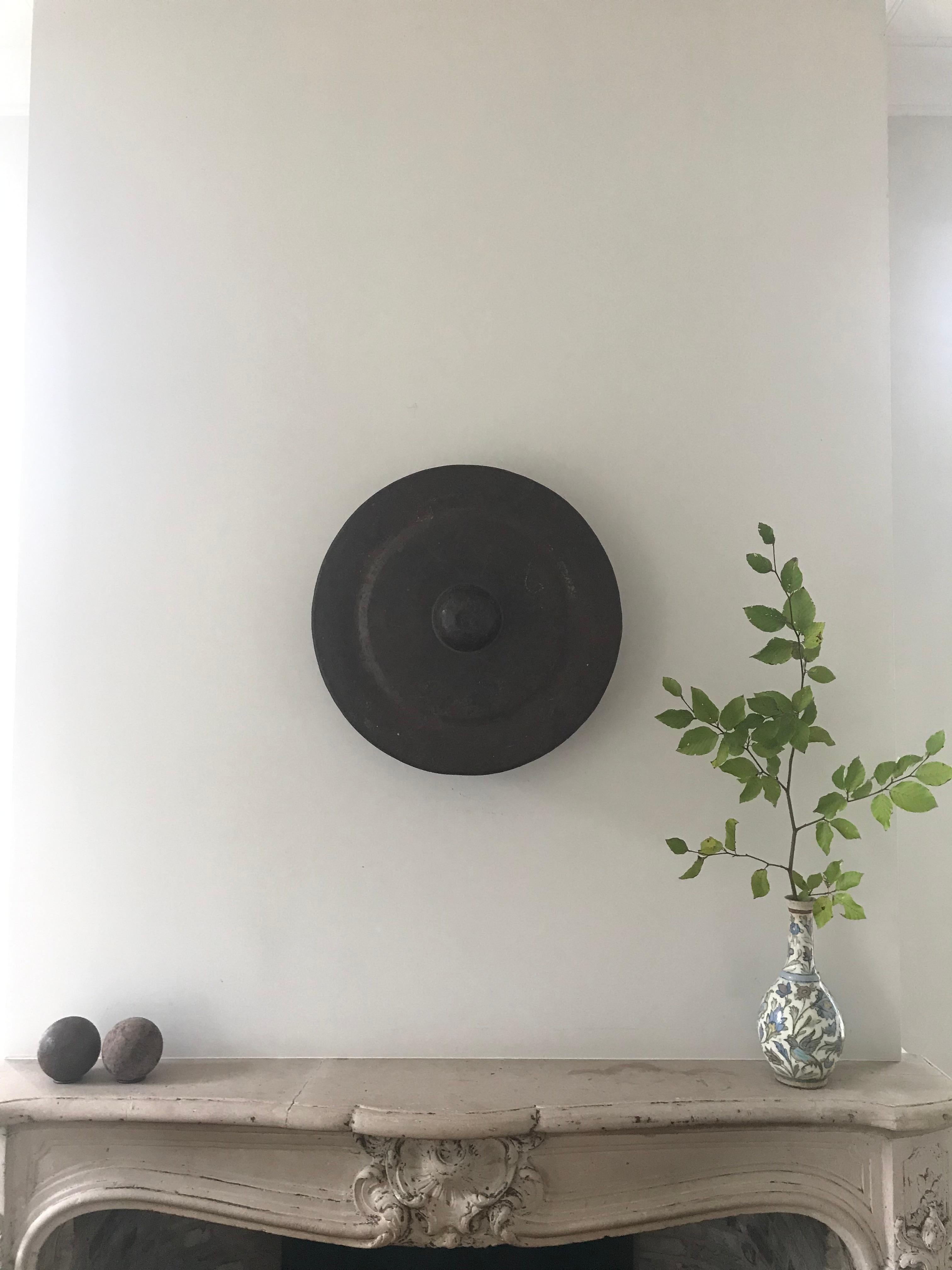This unique Asian item is a percussion instrument in the form of a hanging round bronze plate that is bent at the edge.

Authentic Chinese bronze gong, once used in processions and religious ceremonies.
The sound is literally 'gong'.
The gong