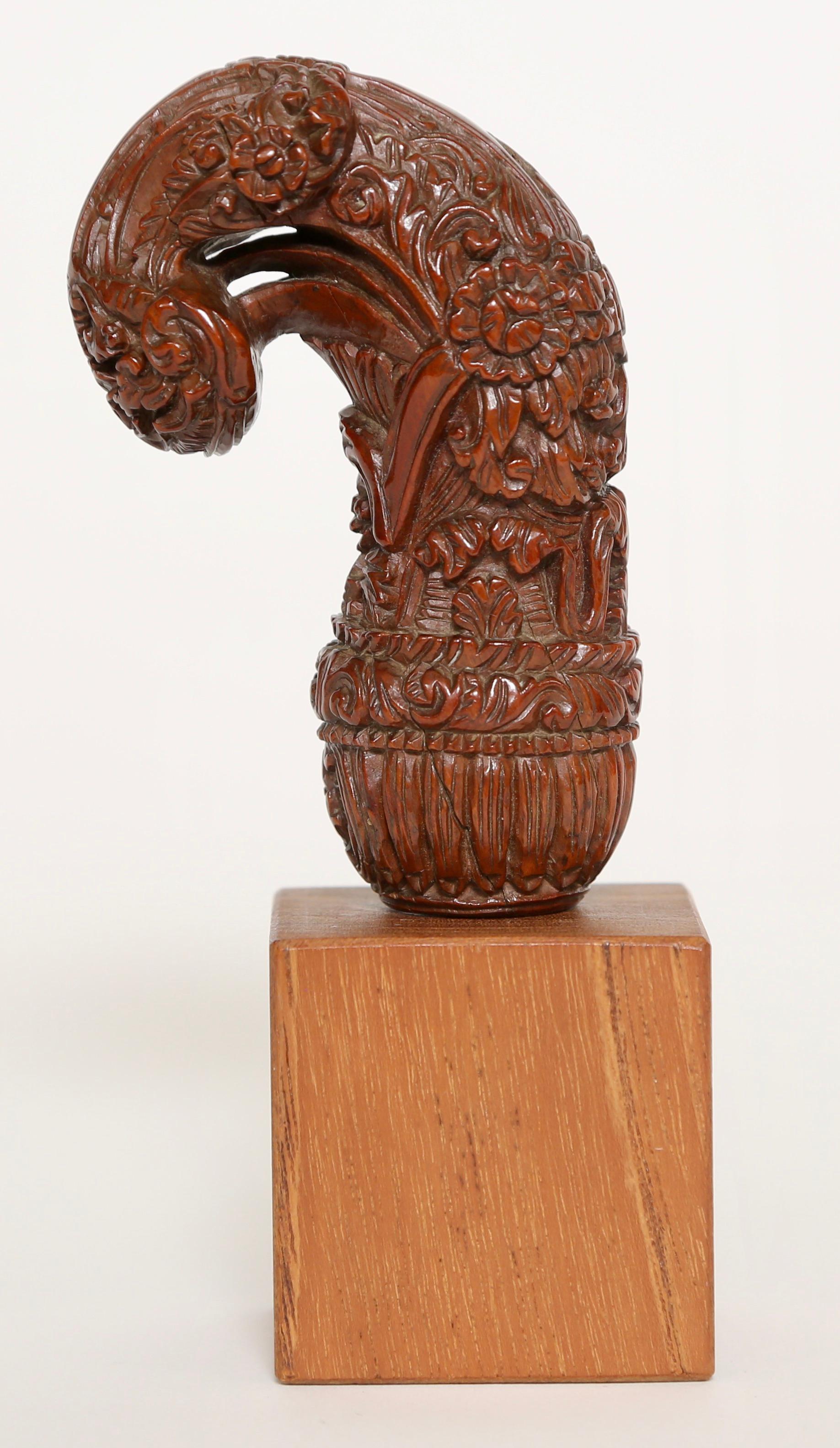 The hilt/handle of this kris (Keris) is meticulously hand carved. This particular Indonesian kris is of Royal quality.    The handle is custom mounted on a museum style wood block.