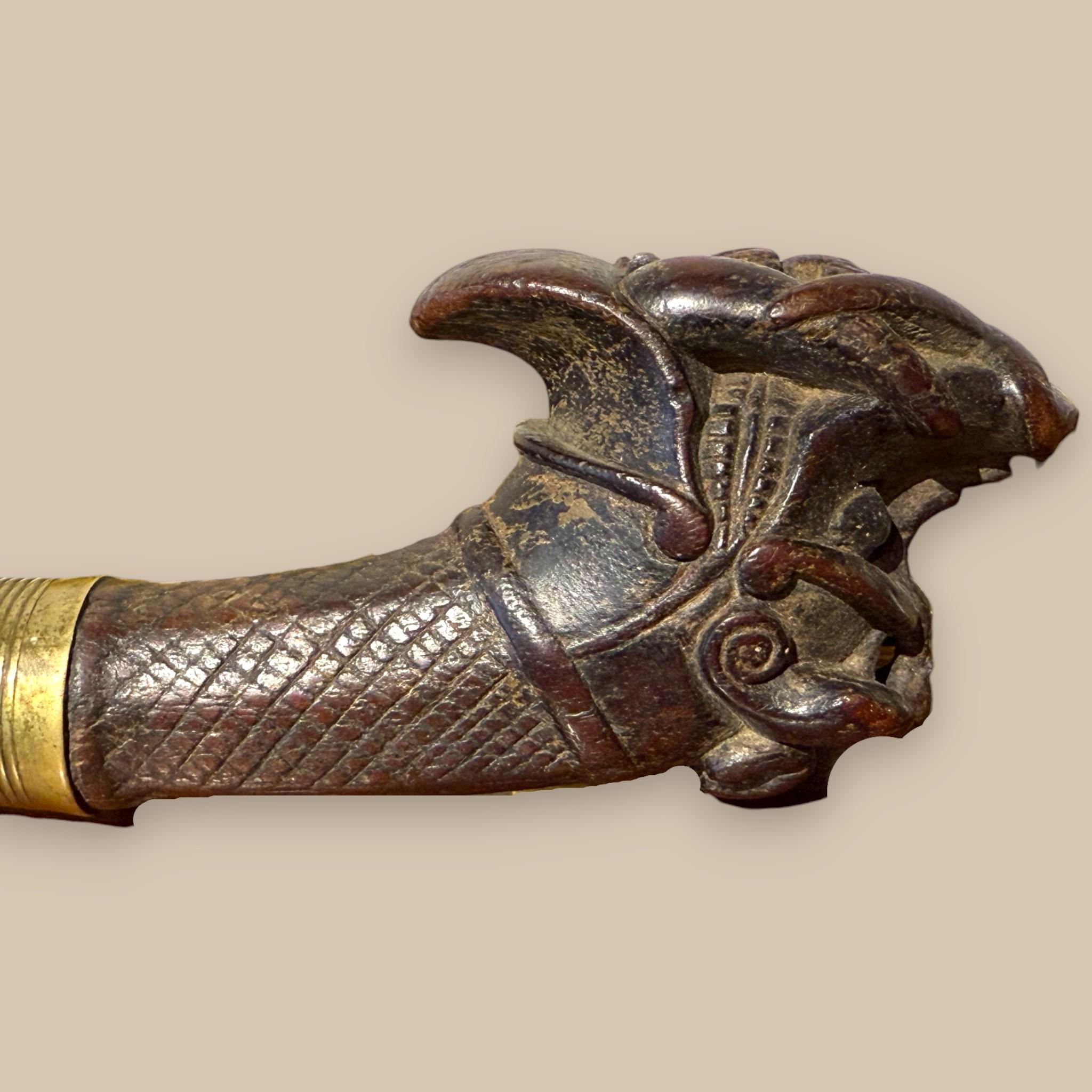 XIX secolo Indonesian Nias Sword with Carved Wooden Hilt and Brass-Bound Scabbard in vendita