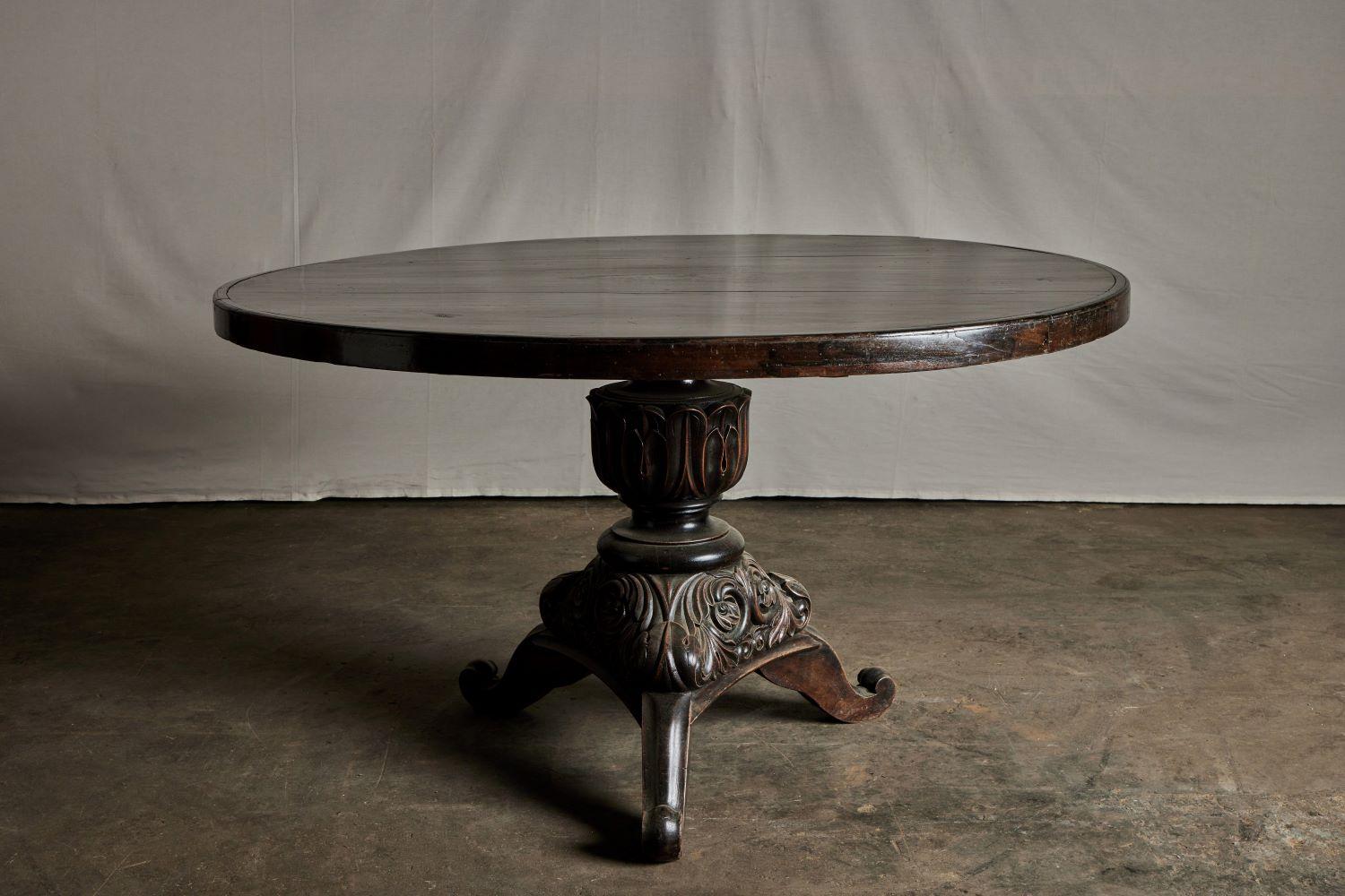 Indonesian pedestal table 54-inch diameter with intricate hand carving on base.