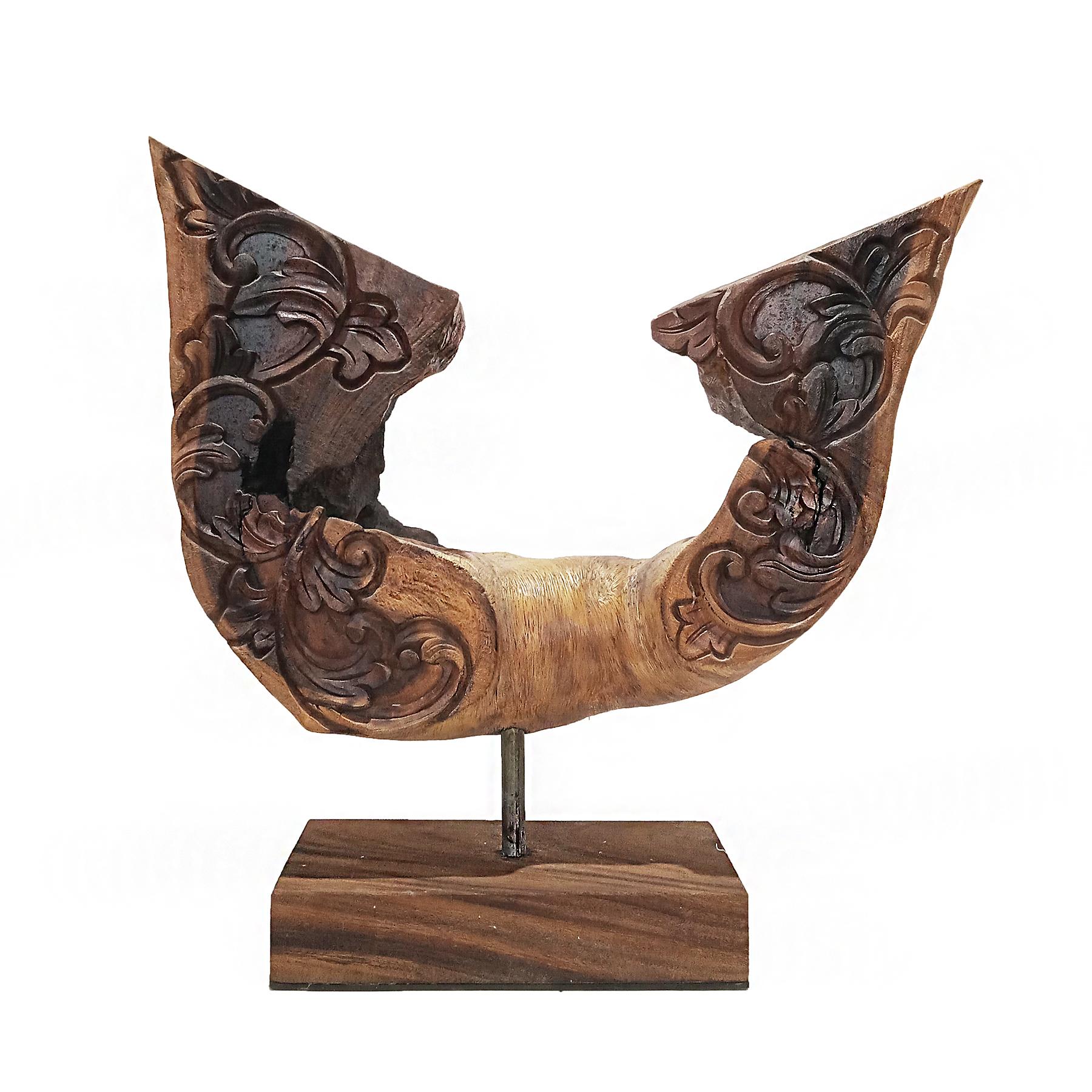 A reclaimed wood sculpture shaped as a pair of wings, hand-carved in Indonesia, late 20th Century. The material is Suar wood (Samanea Saman or Monkeywood), known for its beautiful veining, texture and color. 

Mounted on a reclaimed wood stand.