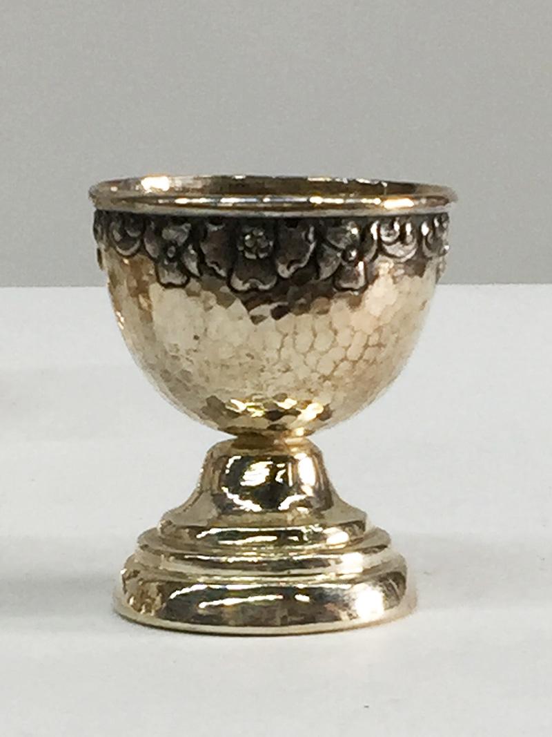 Indonesian Silver Yogya Egg Cups Made by Sastro Sukarto

Six Yogya silver egg cups from the first part of the 20th Century. Marked with the Indonesian hall mark SH800 (silver purity 800/000) SH for the silversmith Sastro Sukarto. Sastro Sukarto has
